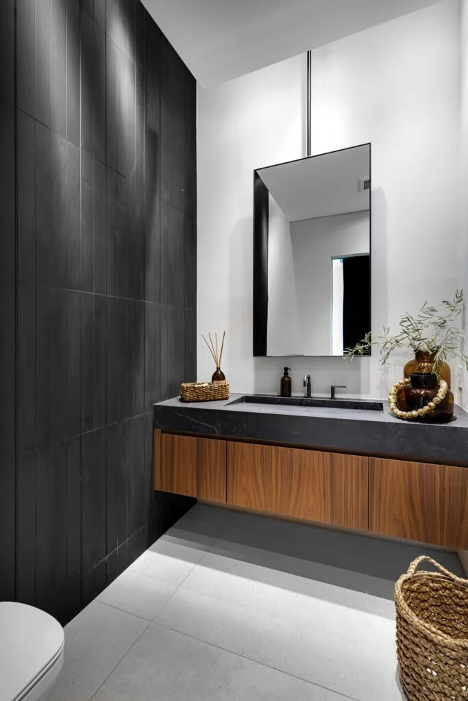Custom timber vanity and integrated black stone trough basin in a South Yarra bathroom renovation