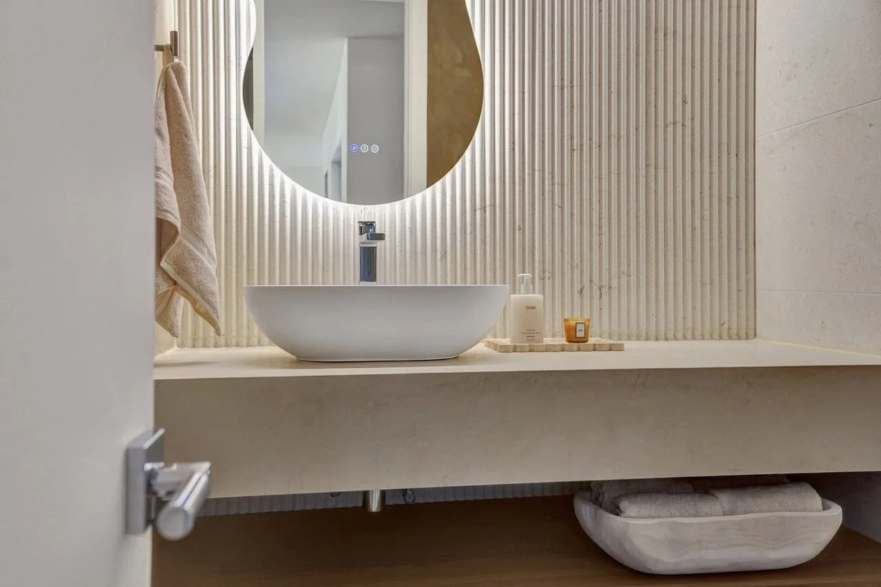 Close up of chrome basin mixer tap against flutted walls in an Essendon home