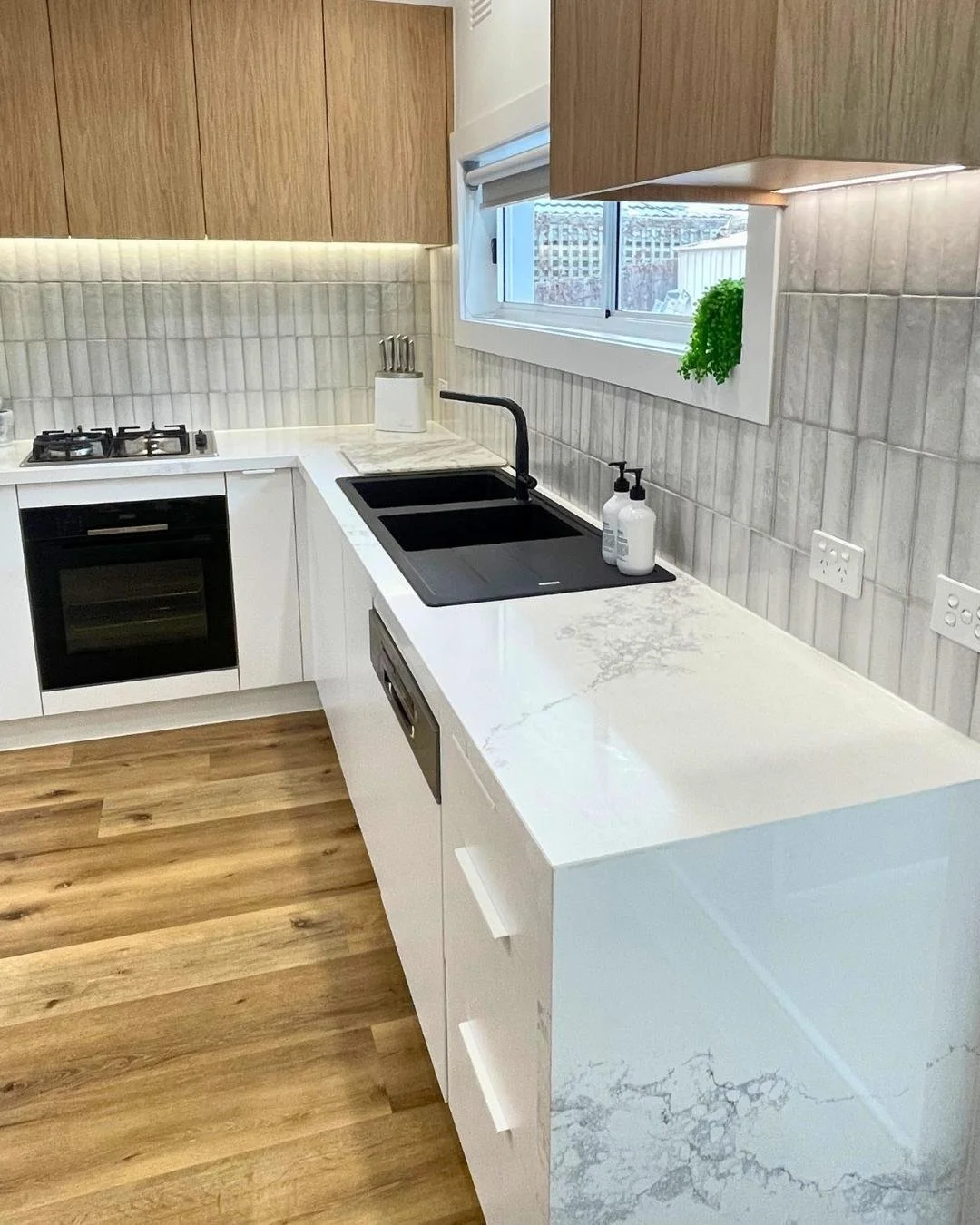 After: luxury Essendon kitchen with marble benchtop and modern appliances