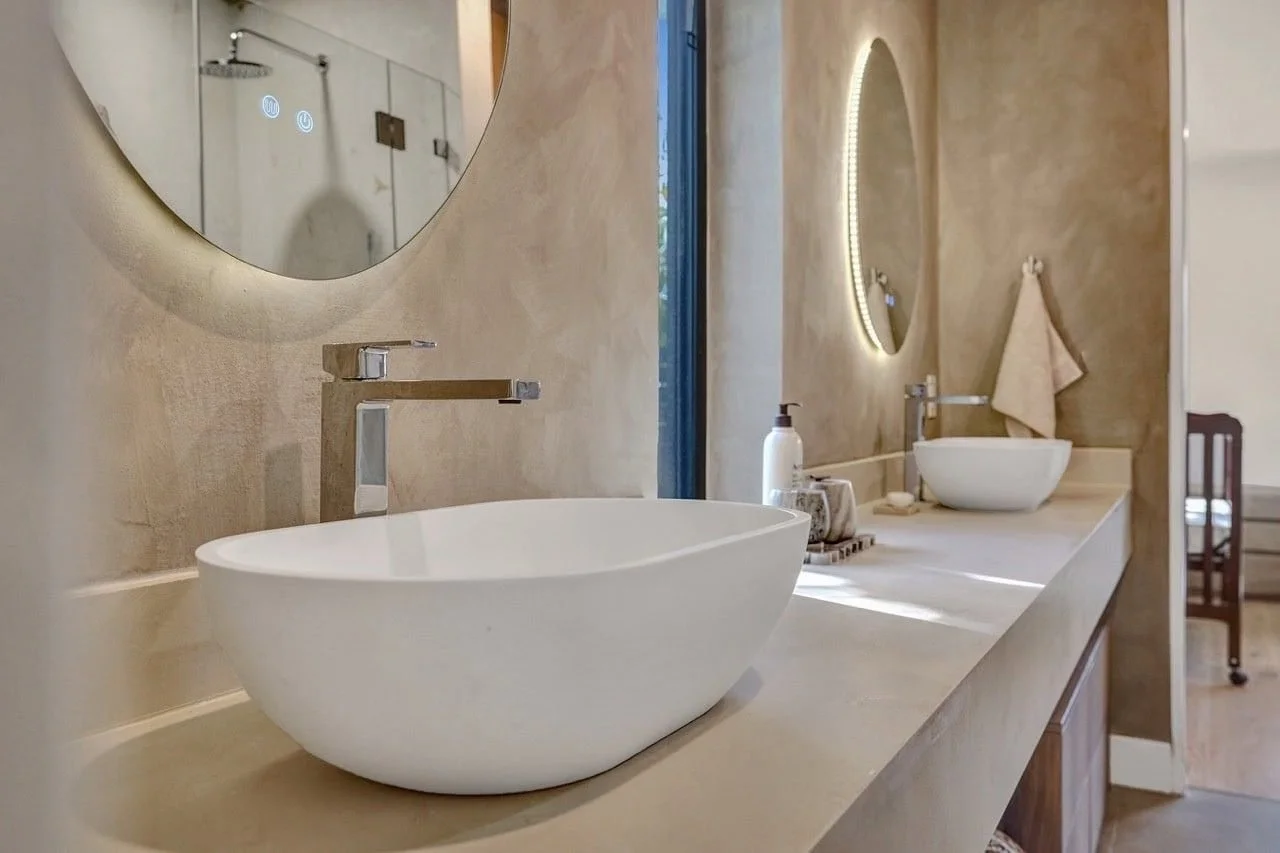 master en suite with double concrete vanities, round mirrors, and glass walk-in shower in Essendon renovation