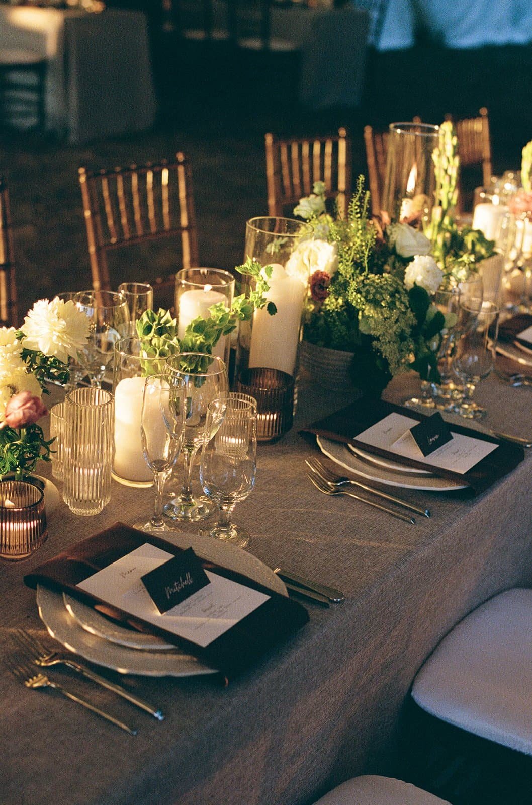 Elegant banquet table setup with floral centerpiece, candles, glassware, and place settings, illuminated with warm lighting at The Goodstone Inn, Middleburg VA