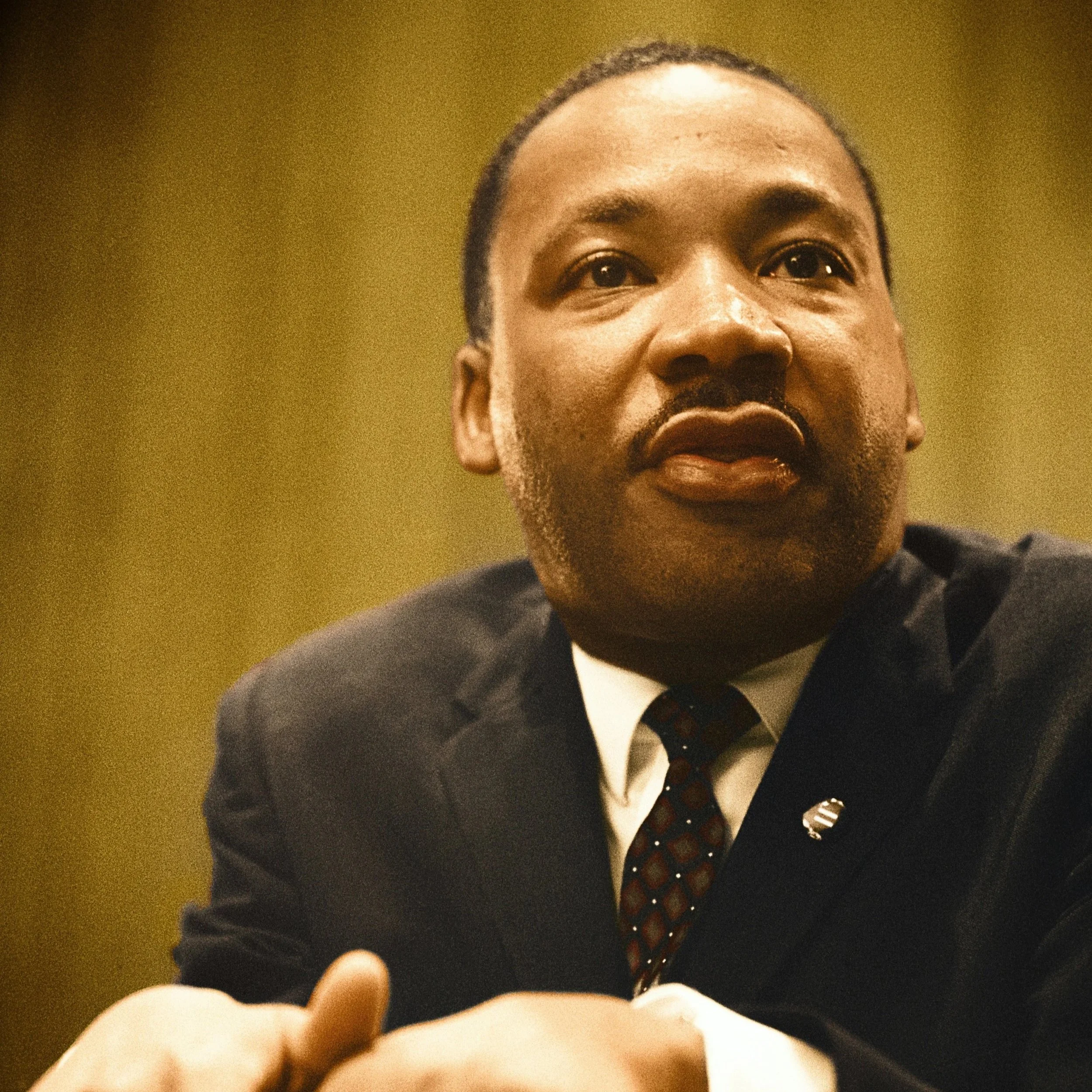 Image of Martin Luther King, Jr. leaning on a podium.