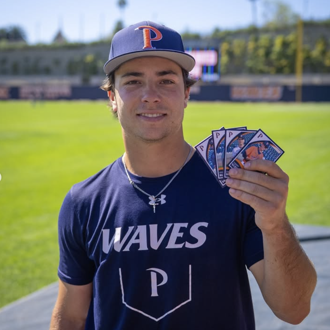 Pepperdine baseball player holding custom team trading cards from the Pepperdine Waves baseball set. Image courtesy of Pepperdine Baseball via Instagram.