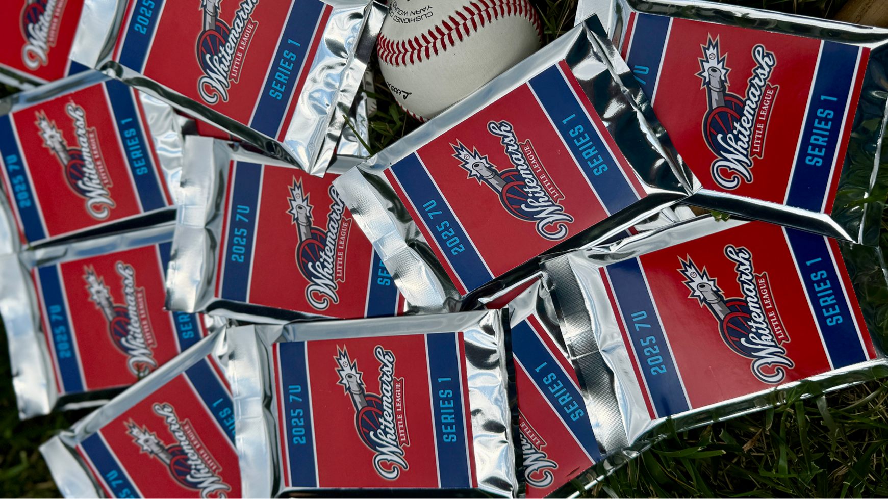 Multiple packs of 2025 TU Whitestone Little League baseballs and a single baseball on grass.