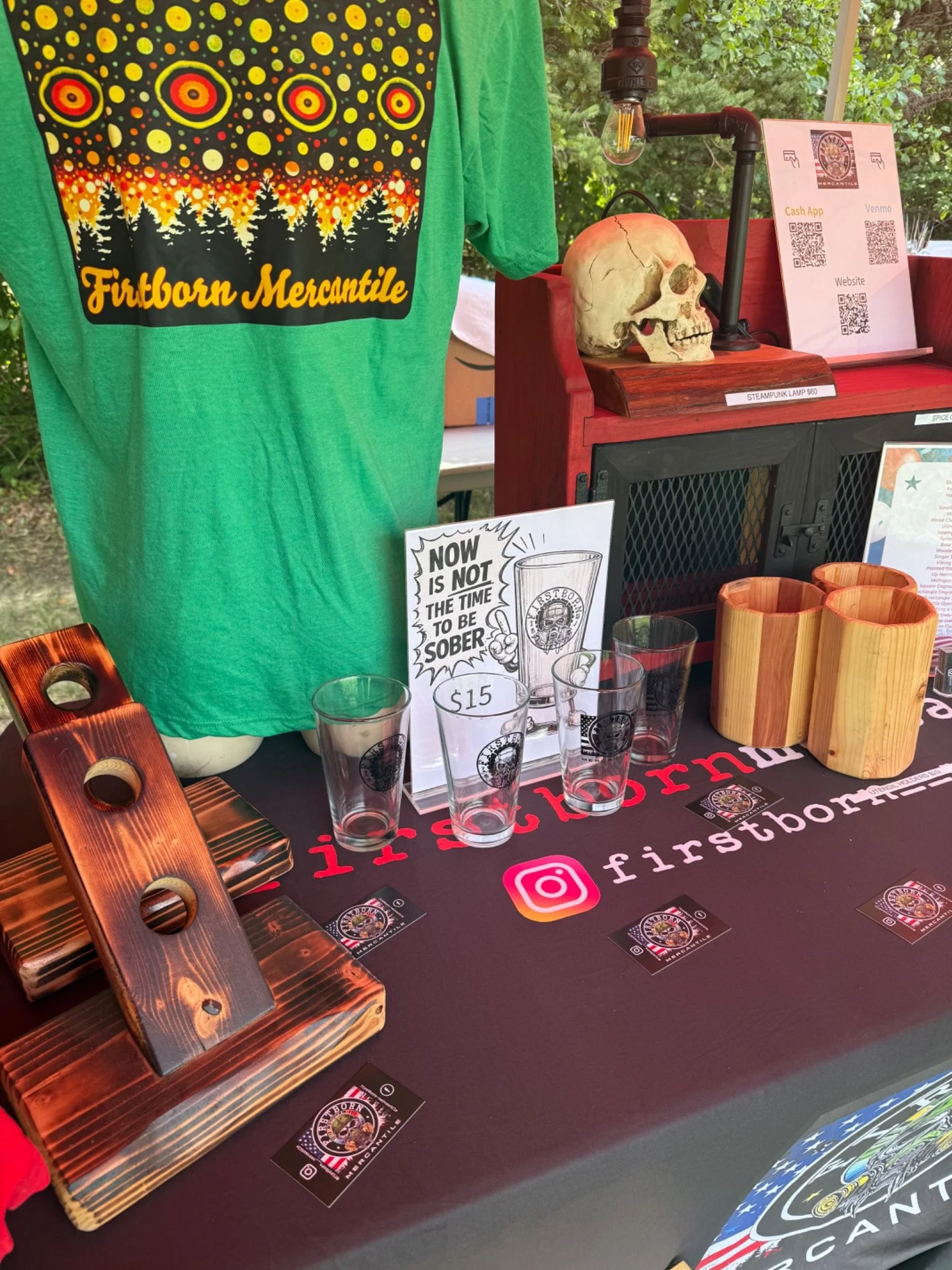 Firstborn Mercantile display with custom apparel, engraved glasses and handmade wood goods
