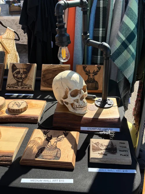 Firstborn Mercantile personalized wood art and steampunk lamp at a market