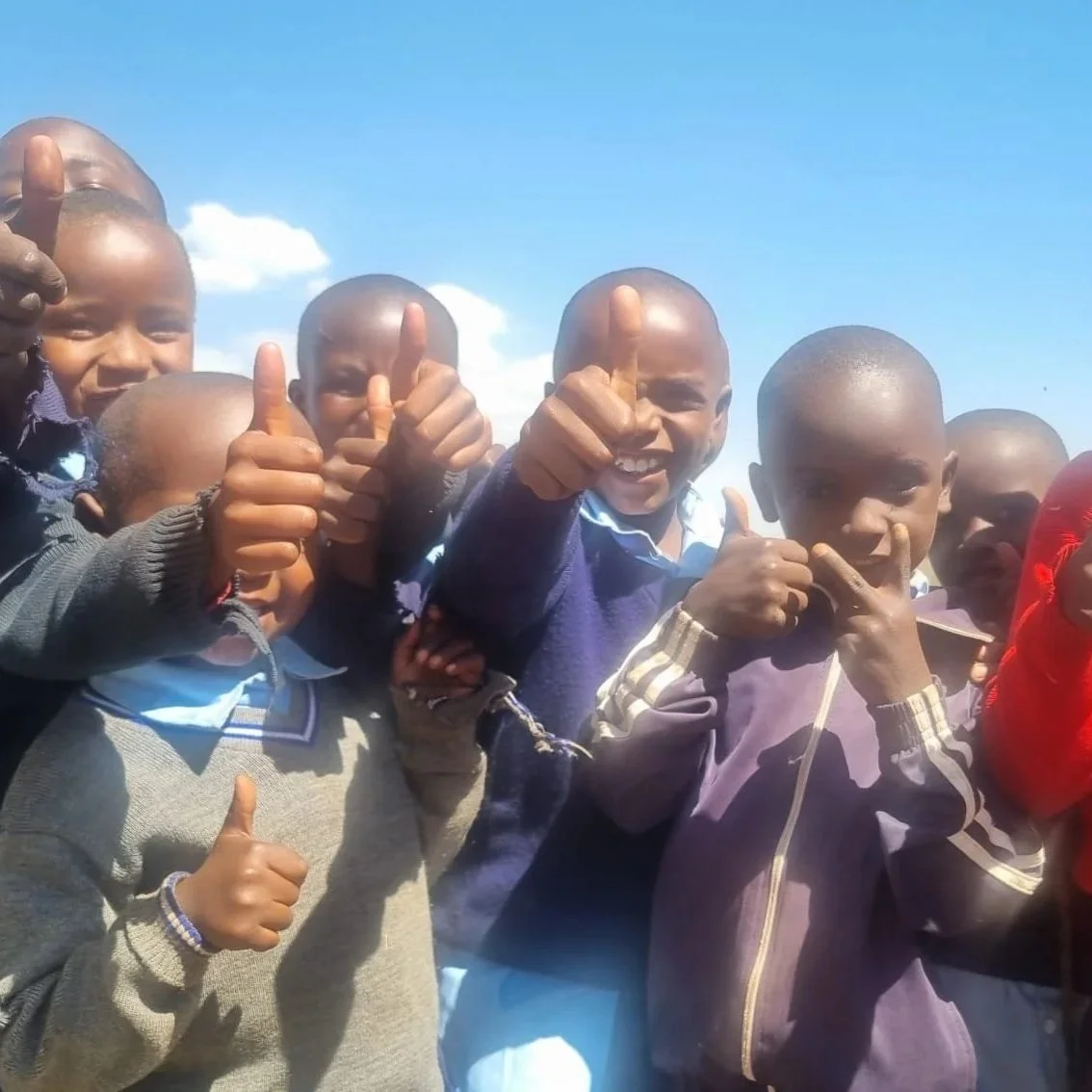 Boys showing thumbs up