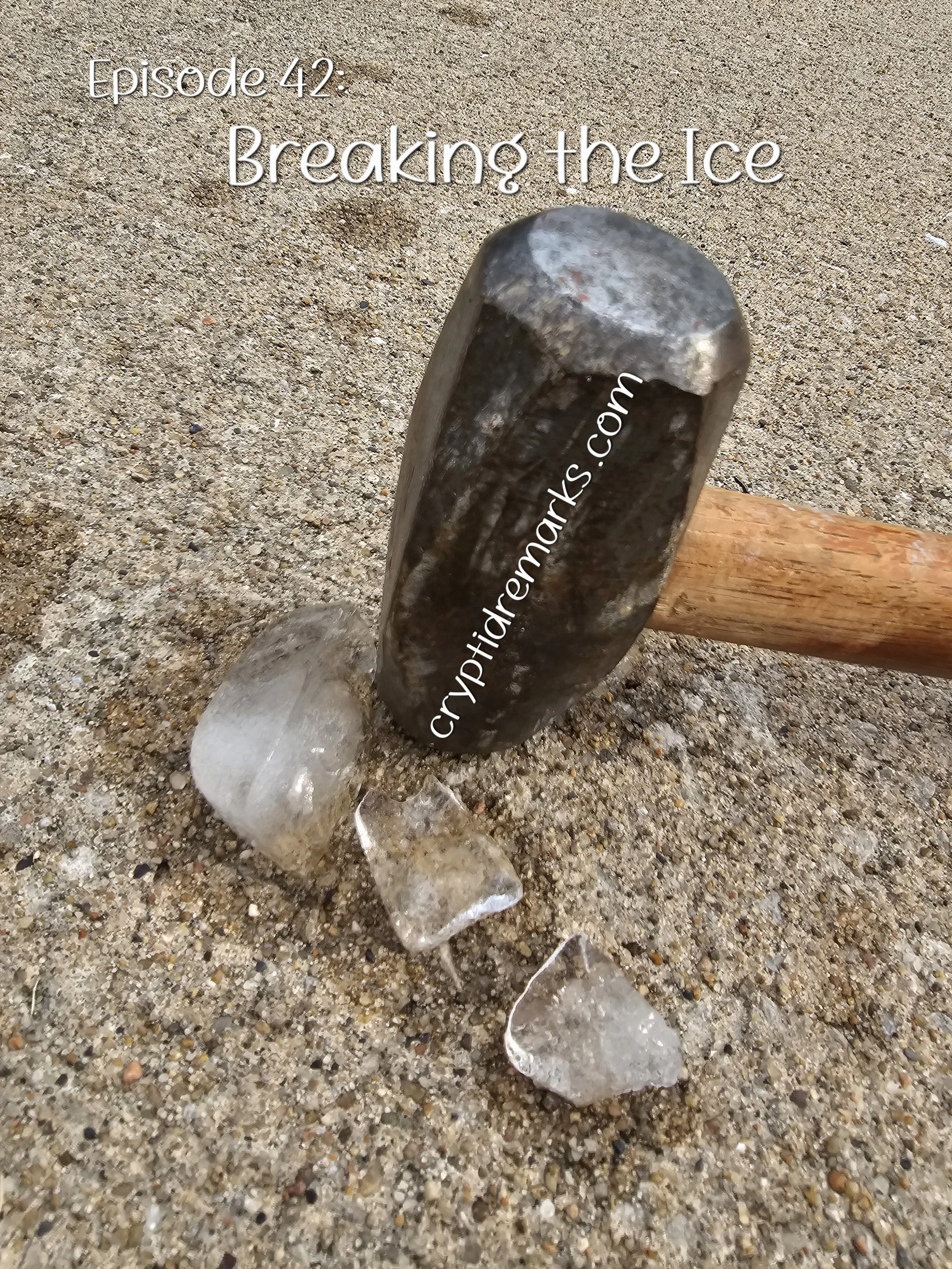 A metal mallet breaking ice cubes on concrete