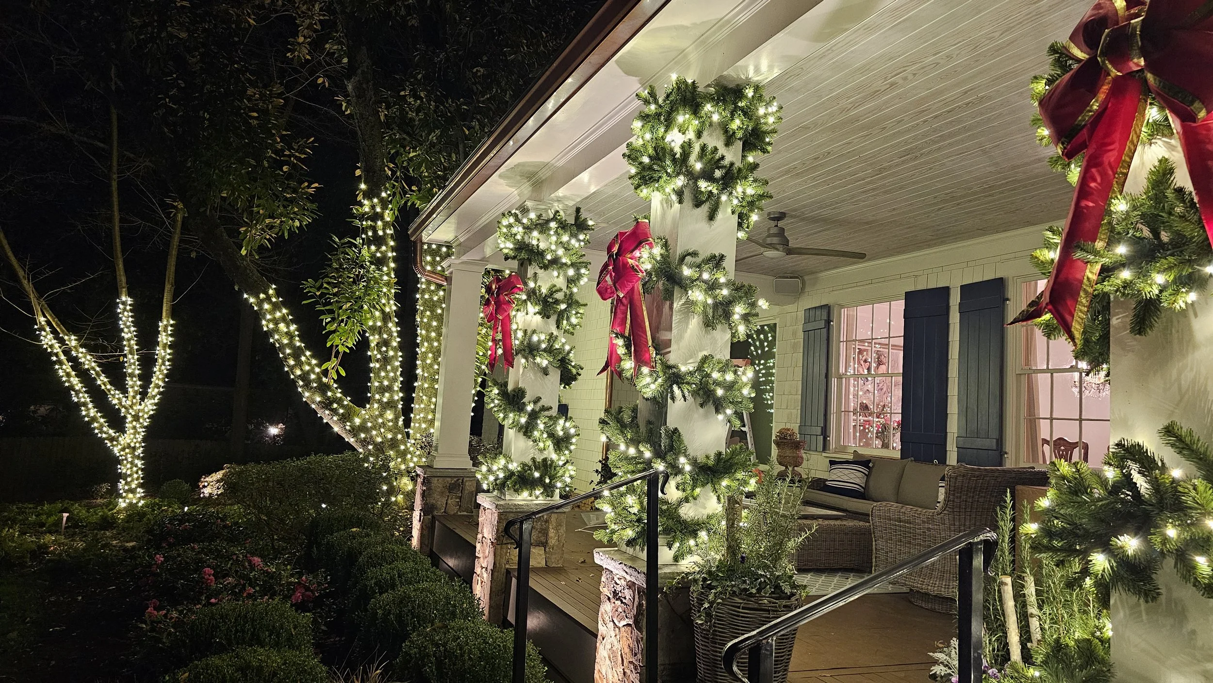Lighted garland columns and Christmas porch decorations on Atlanta home