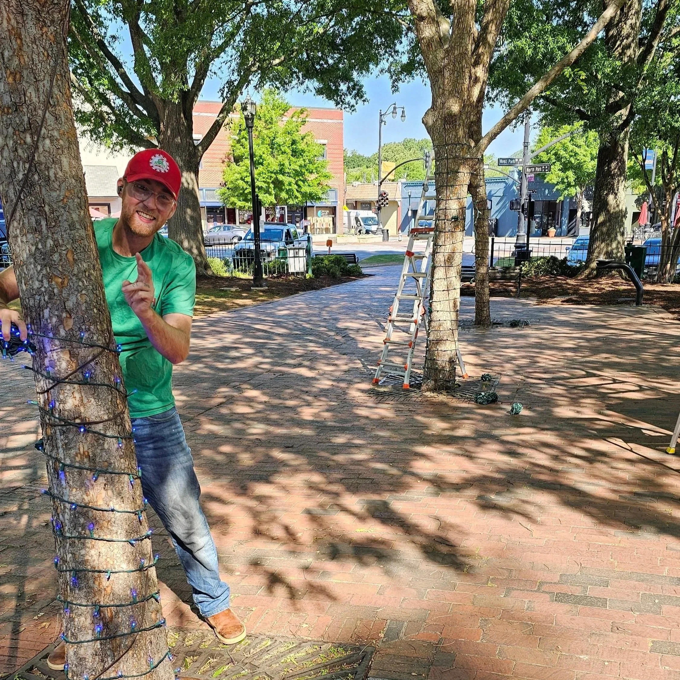 Rich Lighting Co employee installs lights in Marietta Square