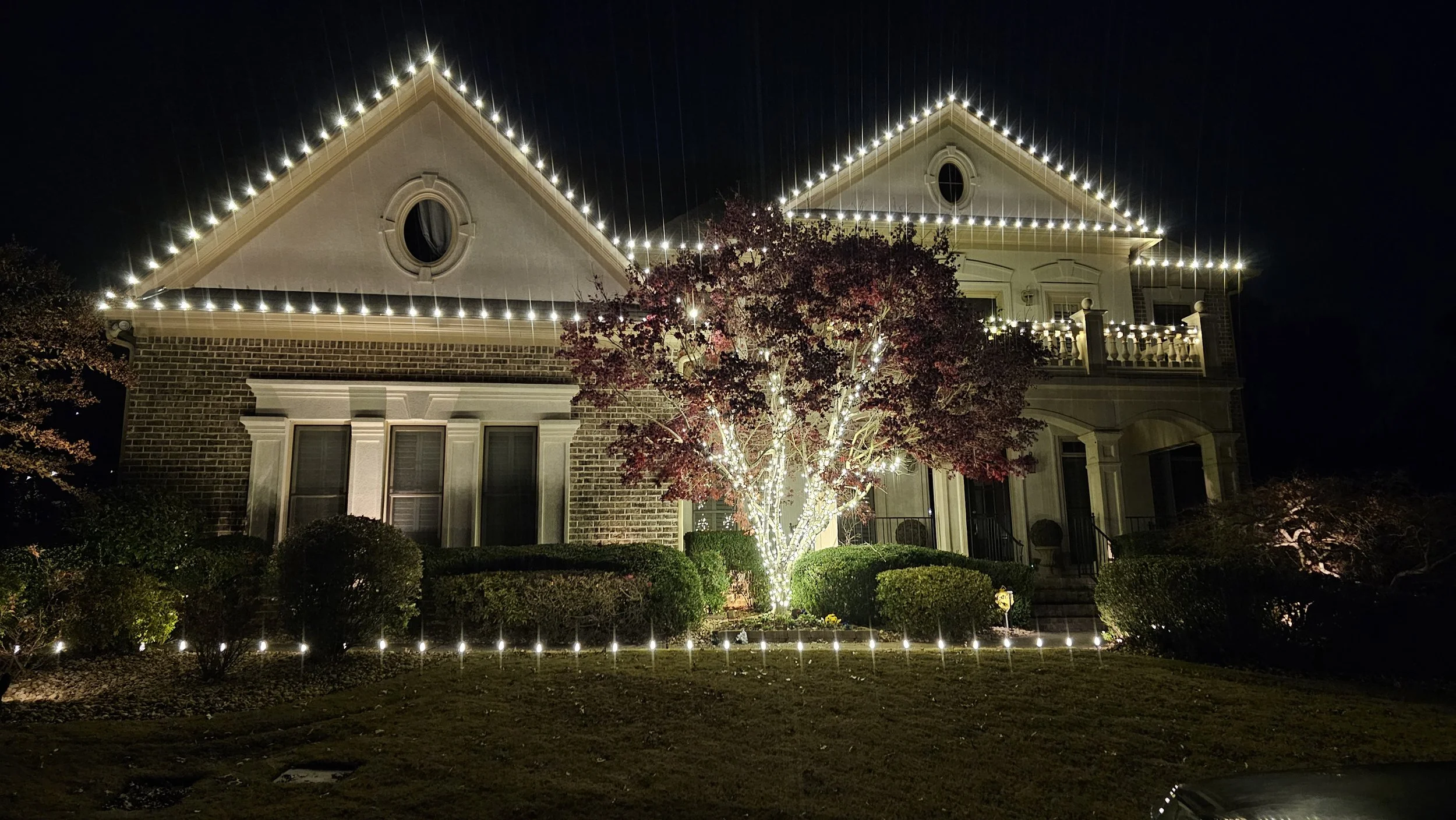 Warm white Christmas light installation Japanese Maple roofline