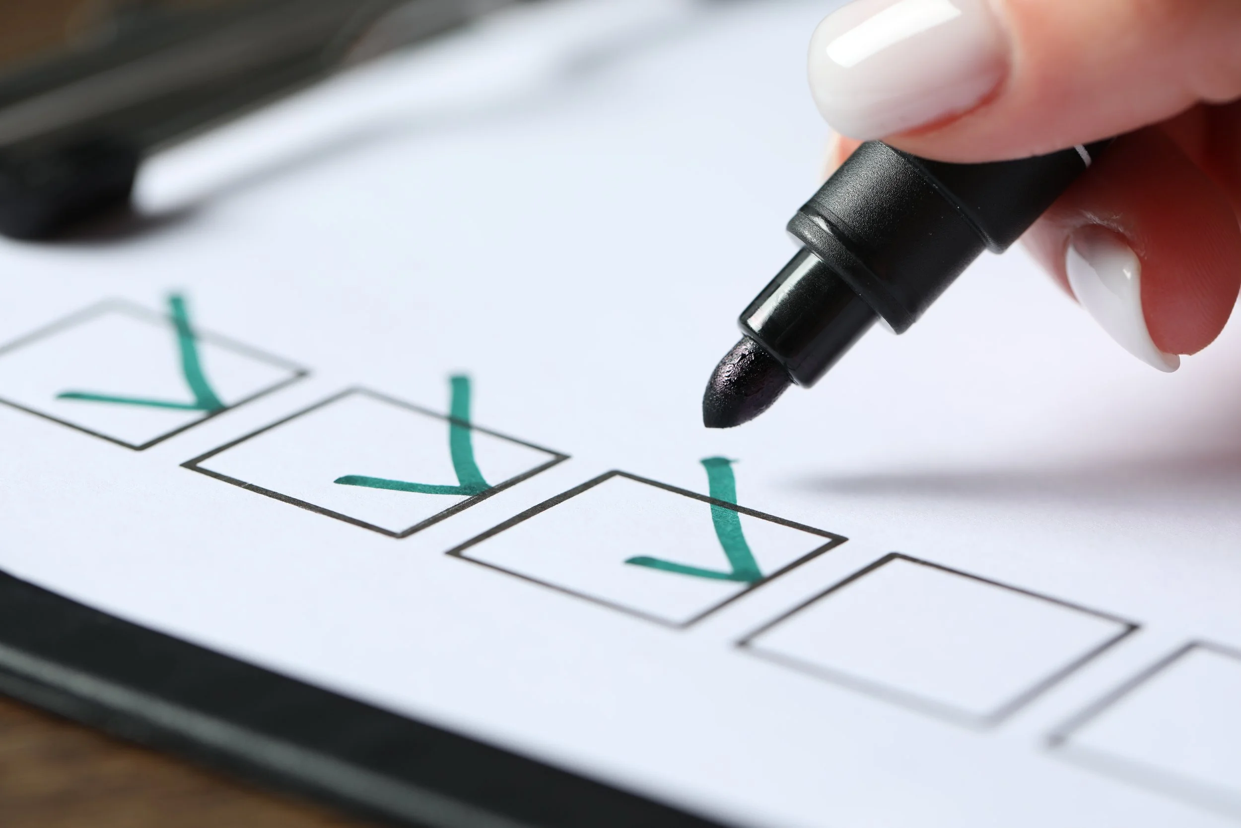 woman-checking-box-of-paper-form-at-wooden-table-2026-03-26-23-57-14-utc.jpg