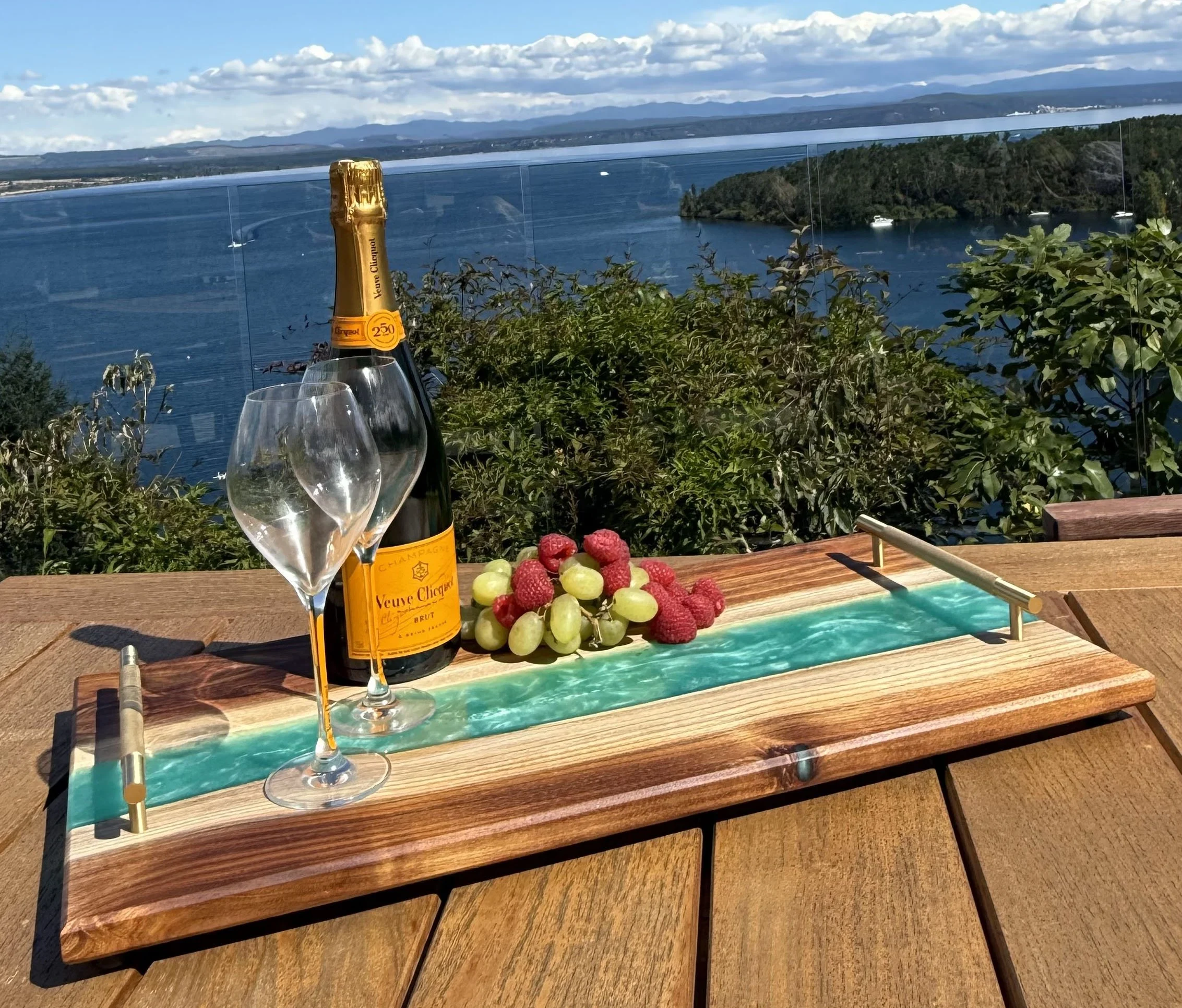 Tasmanian Blackwood charcuterie board with Reef Green epoxy river and brushed brass handles.