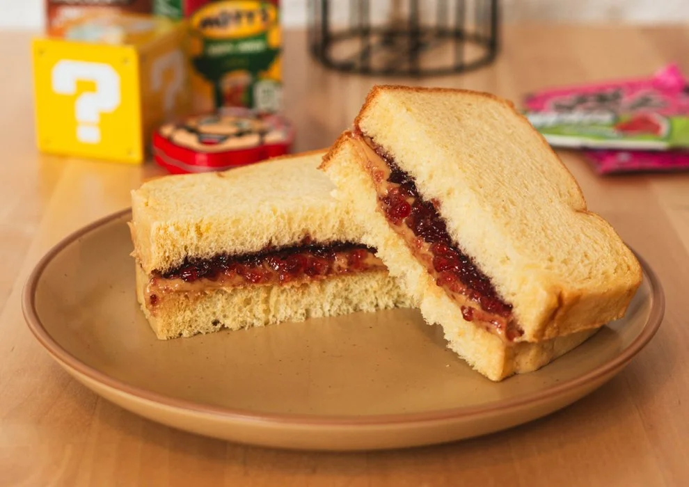 Peanut butter and jelly sliced in half on brioche.