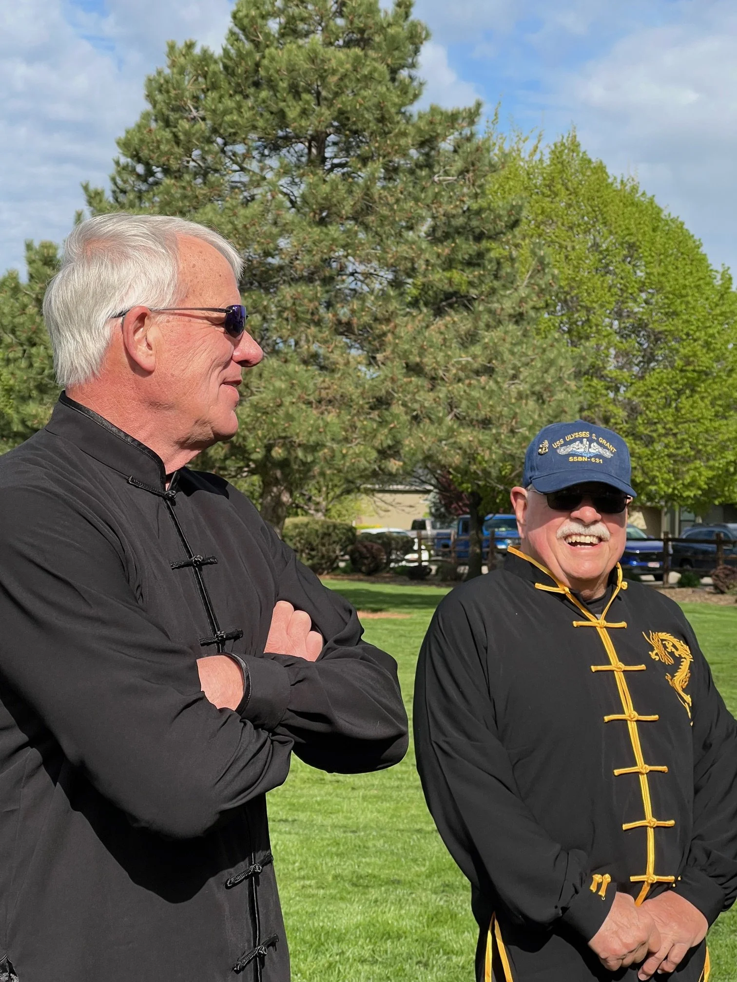 Grandmasters Larry Bearg and Jerremy Stinnet warm up under the sunshine during today's chill weather.