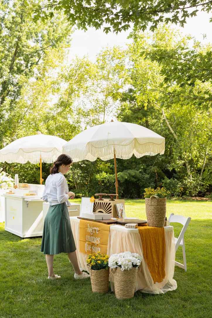 A Cookie Artist sets up her workspace at a backyard baby shower in preparation for an afternoon of live cookie painting.