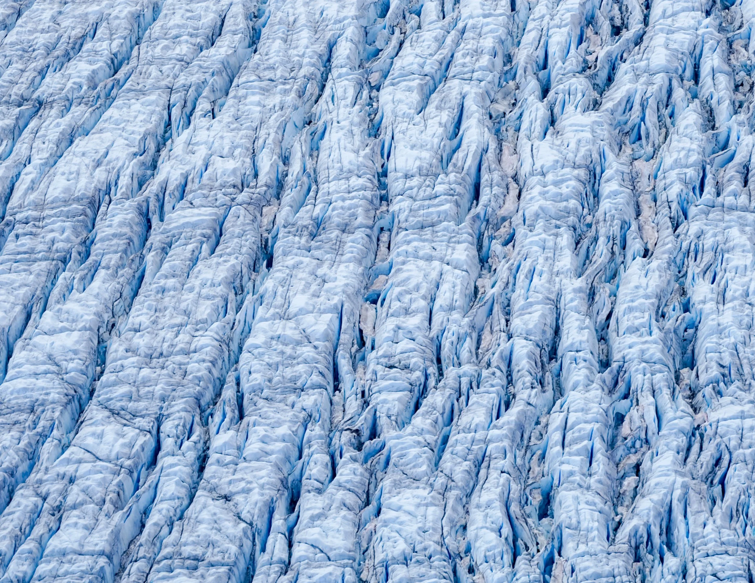Close-up image of a glacier with visible crevasses and blue ice.
