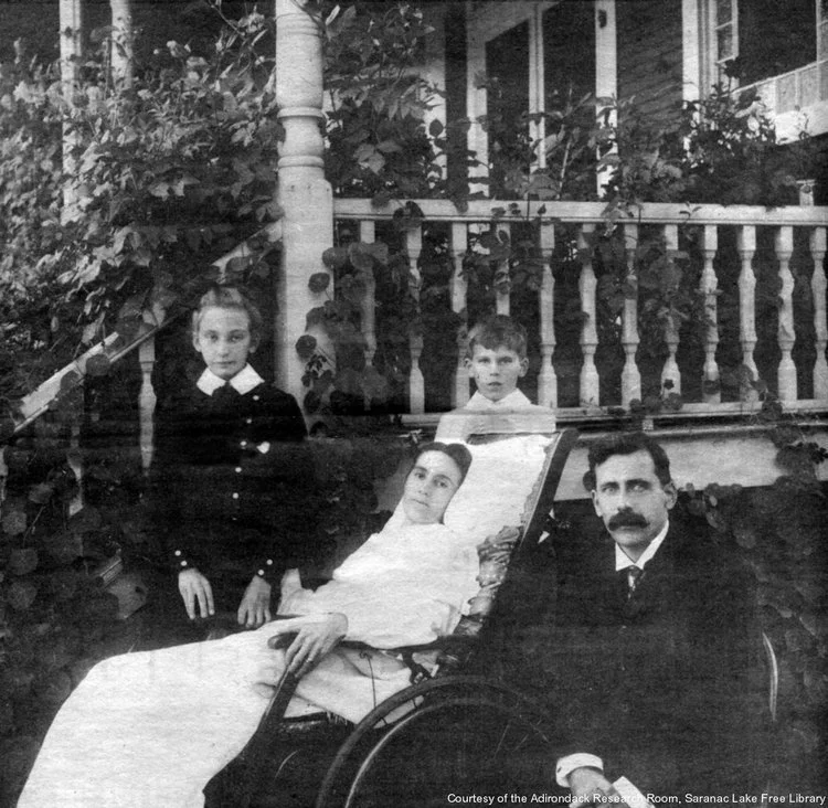 Ailing mother with family outside of the Noyes cottage