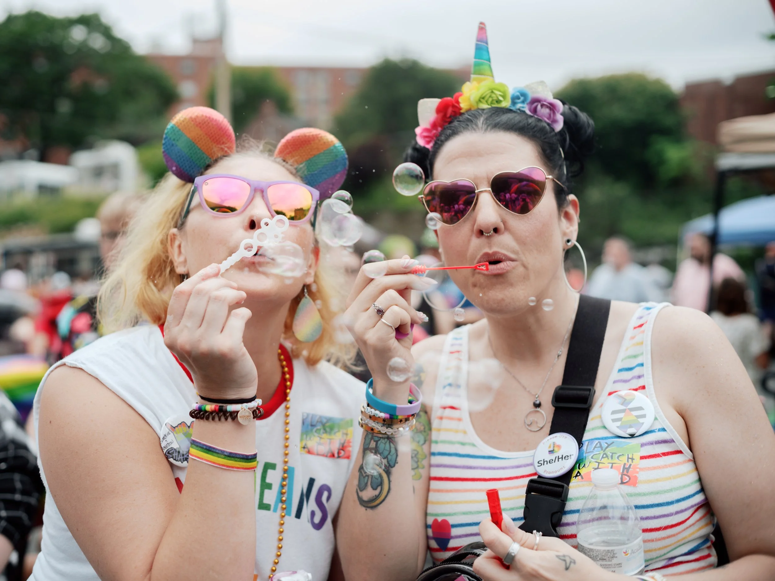 Two attendees at the 2025 Lancaster Pride Festival blowing bubbles and smiling while celebrating together