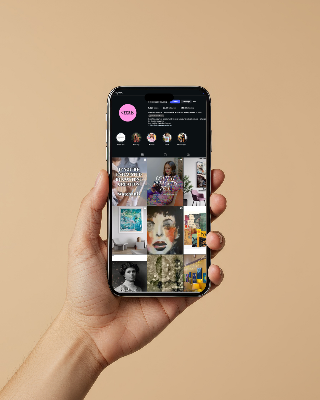 Hand holding a smartphone displaying an Instagram profile page with various posts and images.