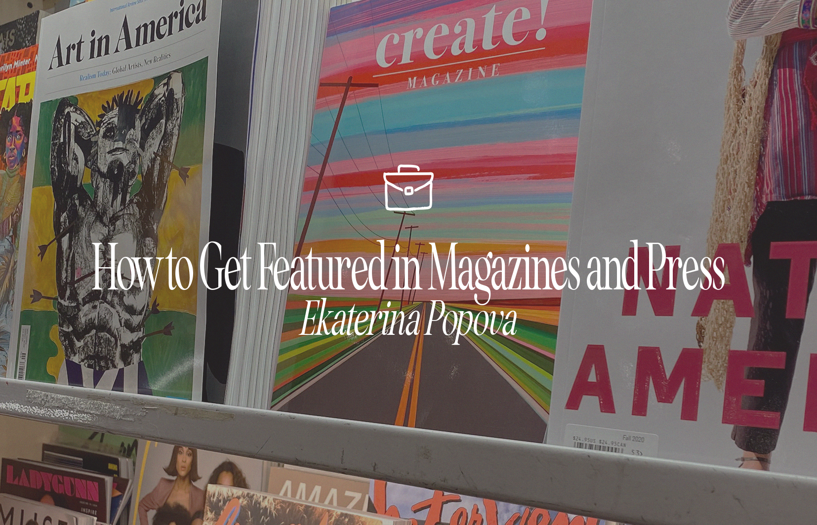 Display of magazines on a store shelf, including "Art in America" and "create! MAGAZINE" with colorful cover art.