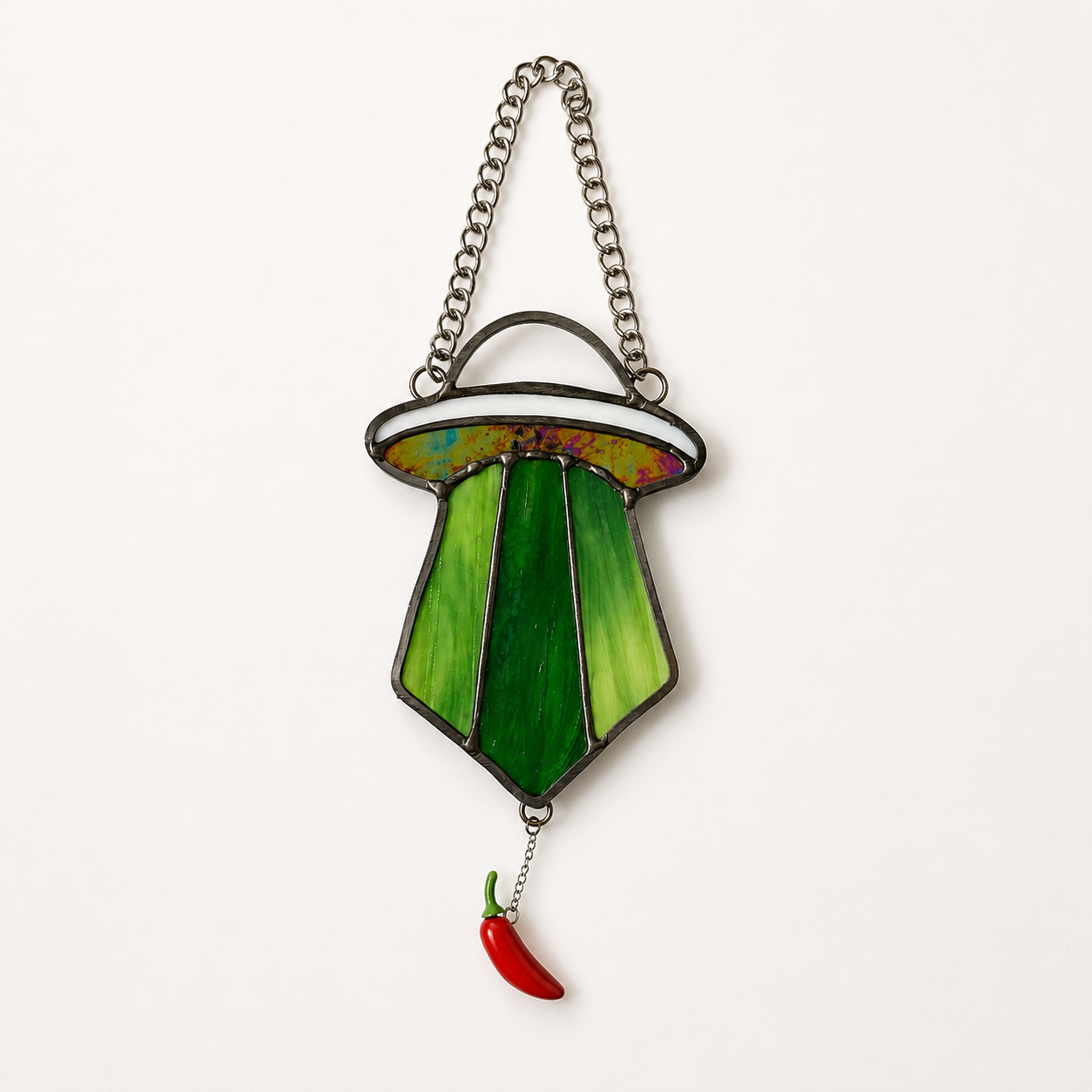 UFO ornament abducting a red chili pepper