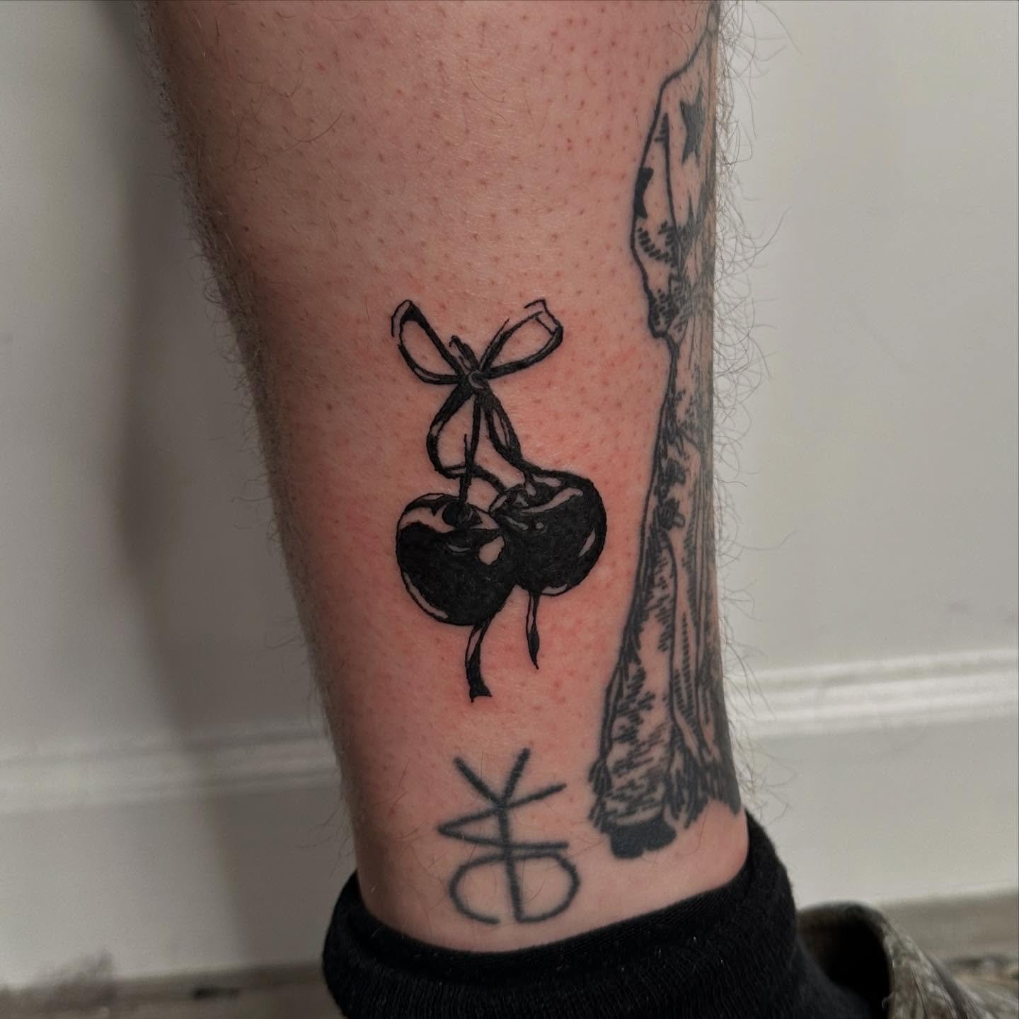 🍒🖤 by @saintshivs 

We love these blacked out cherries by Shivs! They usually work in the world of black and grey, cybersigilism, and text🖊️ But! have been looking to incorporate more color into their pieces🌈

Use the link in our bio or reach out