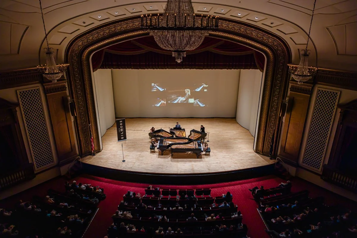 The 5 Browns playing on five Steinway pianos in concert featuring new keyboard projections at The Gilmore Festival in Chenery Auditorium.