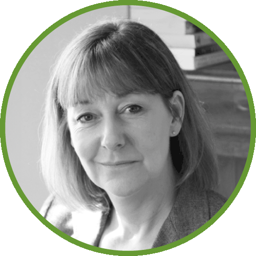 Dr Adrienne Key wearing a blazer, surrounded by a green circular border.