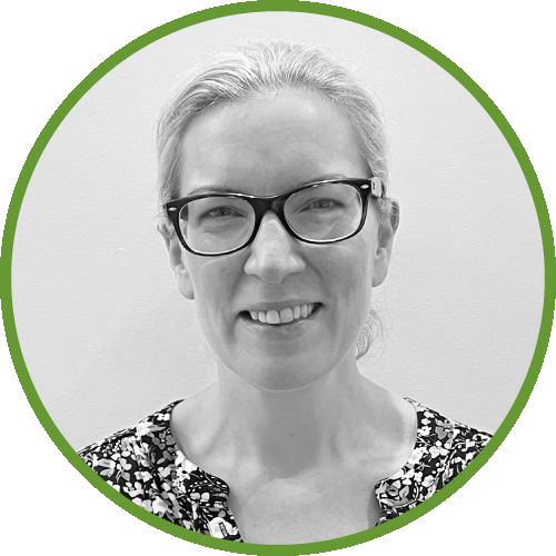 Dr Joanne Spoors wearing glasses, smiling, and a patterned top, set against a plain background with a green circular border.