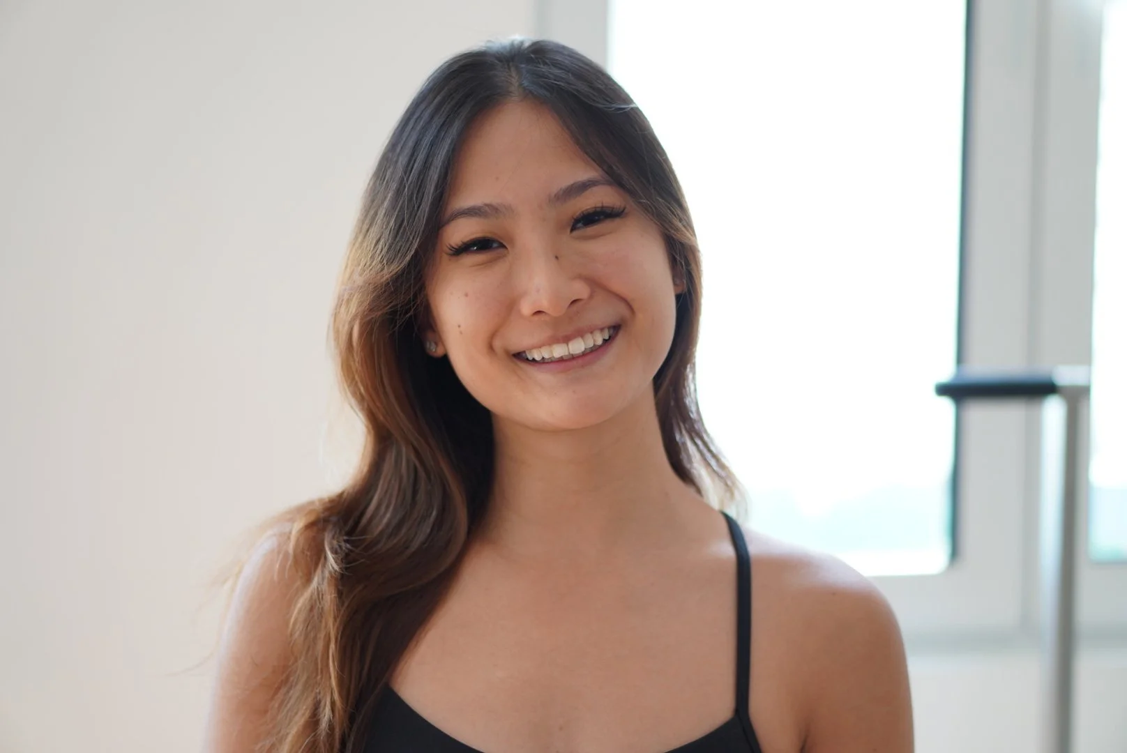 Gray silhouette of a woman with shoulder-length hair inside a circular frame.