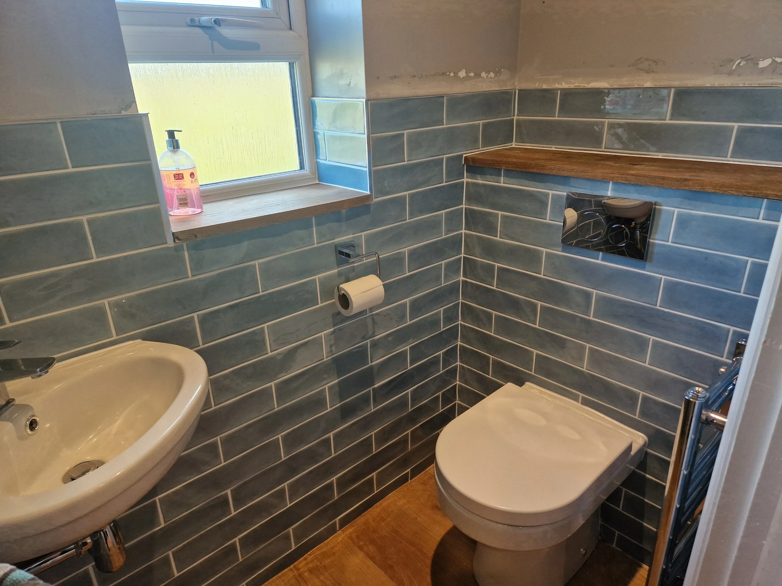 Completed downstairs toilet, complete with oak shelves and a towel rail.