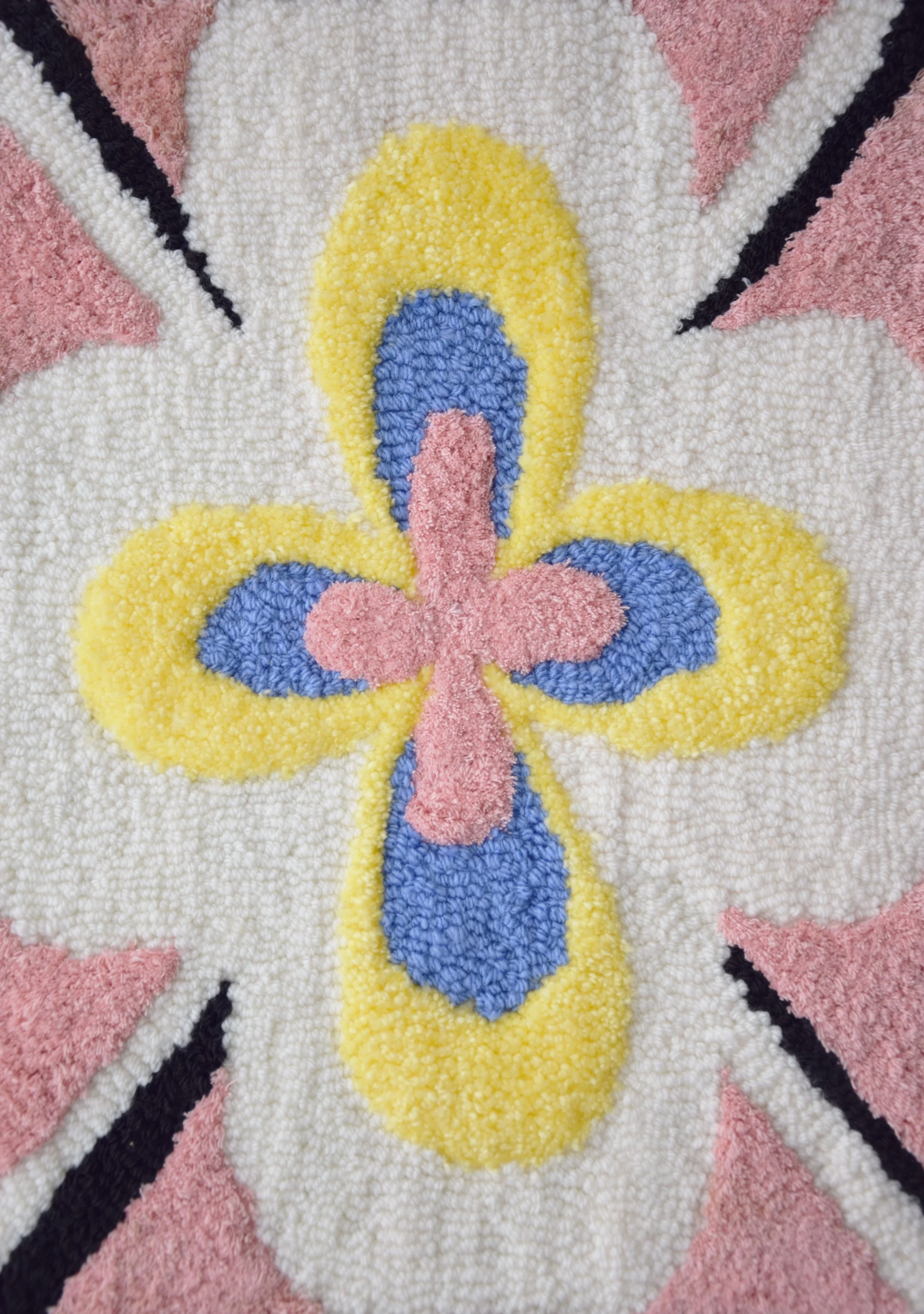 Close-up of a colorful, textured floral pattern with pink, yellow, blue, black, and white sections. Inspired by Hilma af Klint.