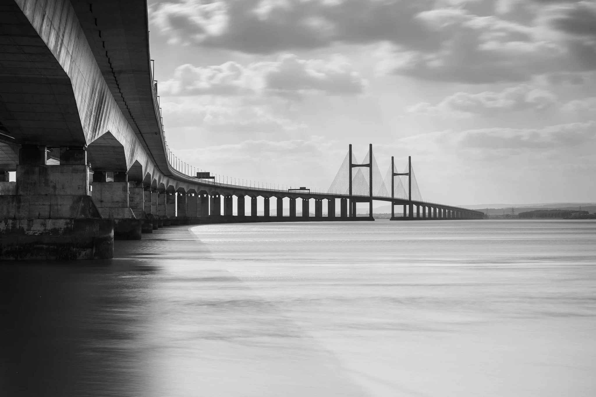 A long-exposure of the Prince of Wales bridge (also known as the second Severn crossing) that links England with Wales across the estuary of the River Severn. Taken in the late afternoon from Severn Beach.