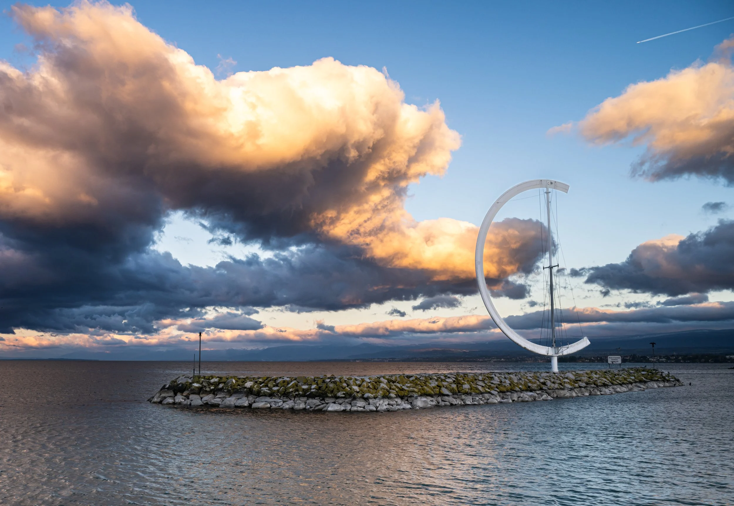 A photo of highly textured clouds as a backdrop for a wind sculpture