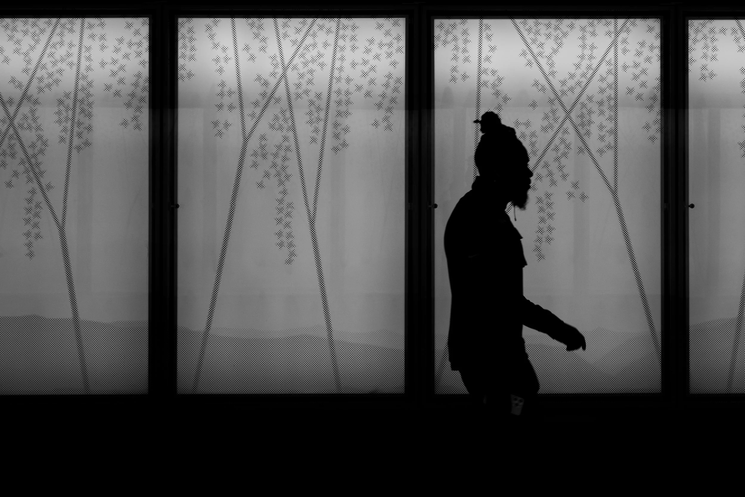 A silhouette of a man listening to music