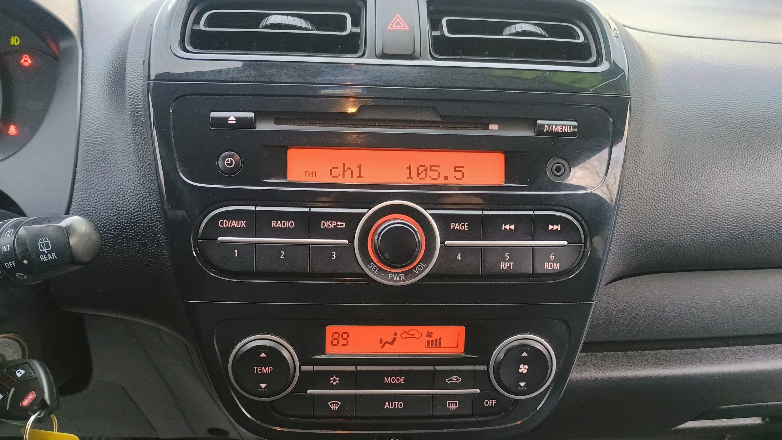 Car radio displaying FM station 105.5 labeled as 'ch1,' climate control with temperature set to 89 degrees, and various control buttons.
