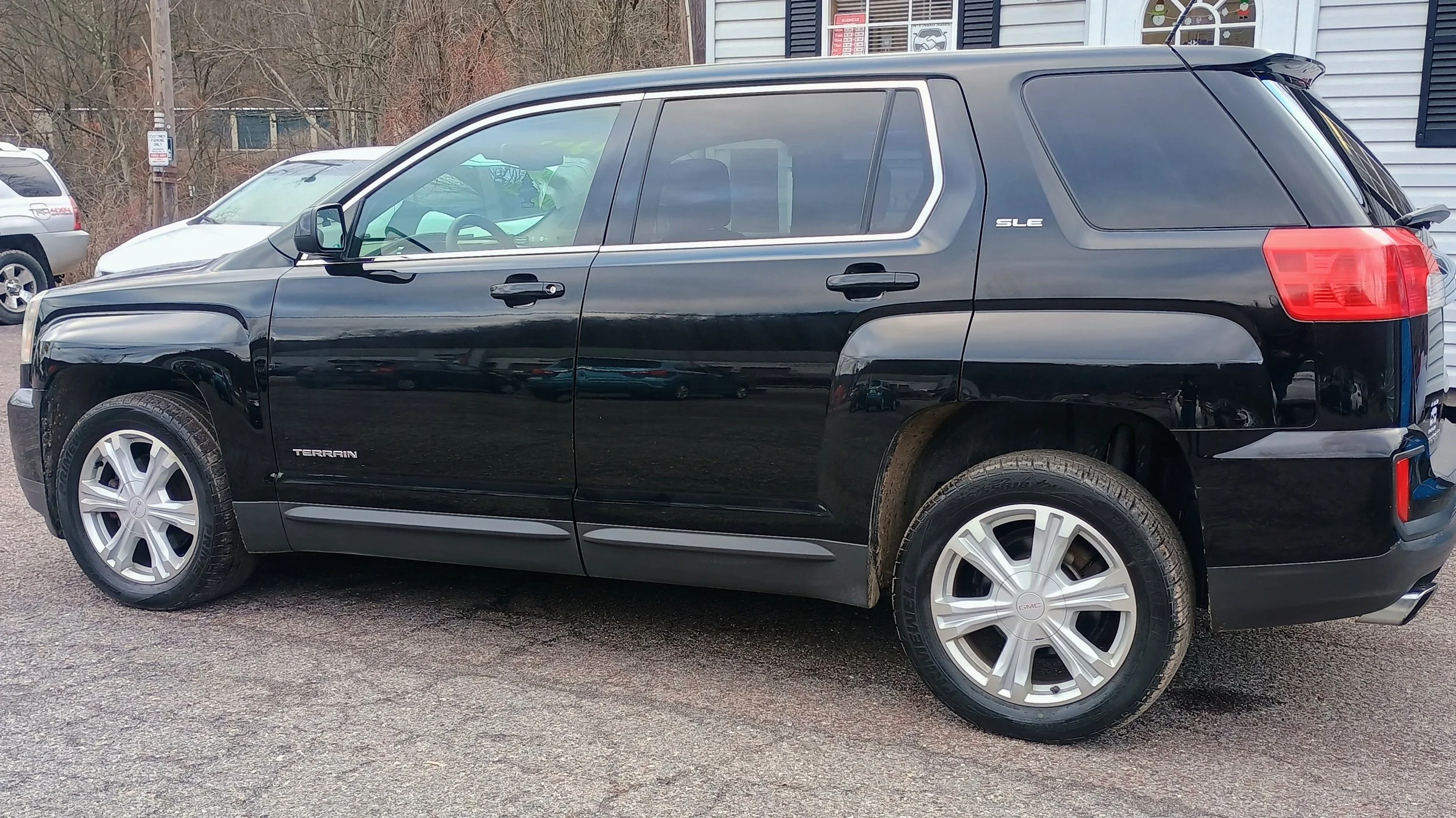 Black GMC Terrain SLE parked at a dealership.