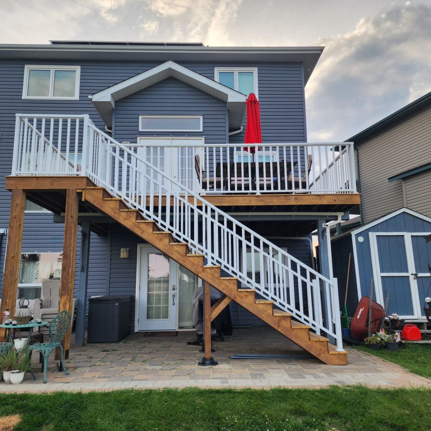 It's the summer we forgot to take before pictures... 

This customer was annoyed having to take their dogs from the first floor into the basement to go outside and again to let them in. 

So we demo'd the 2x6 decking, installed a new landing and stai