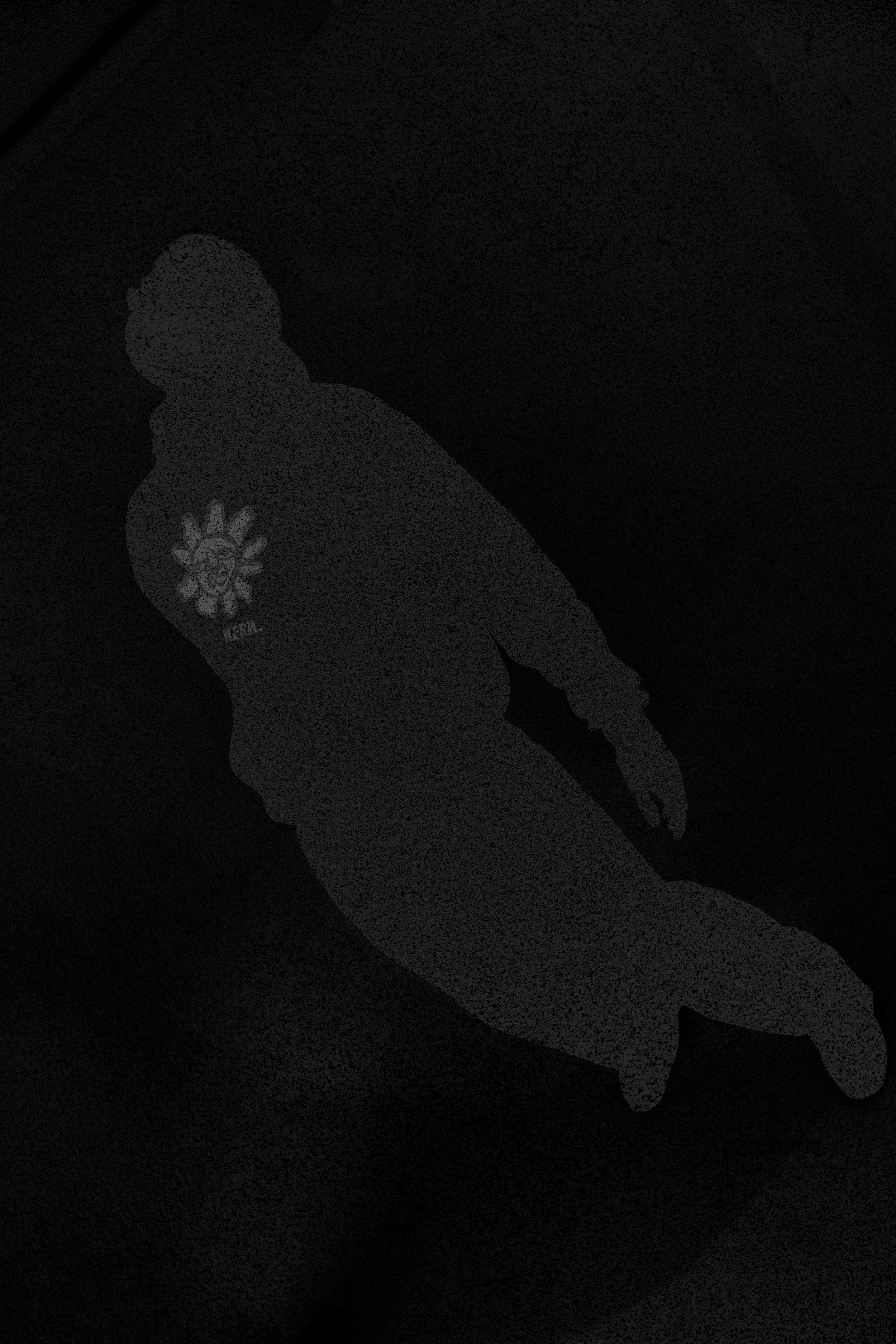 Silhouette of a person in a hoodie with a flower emblem, standing against a dark background.