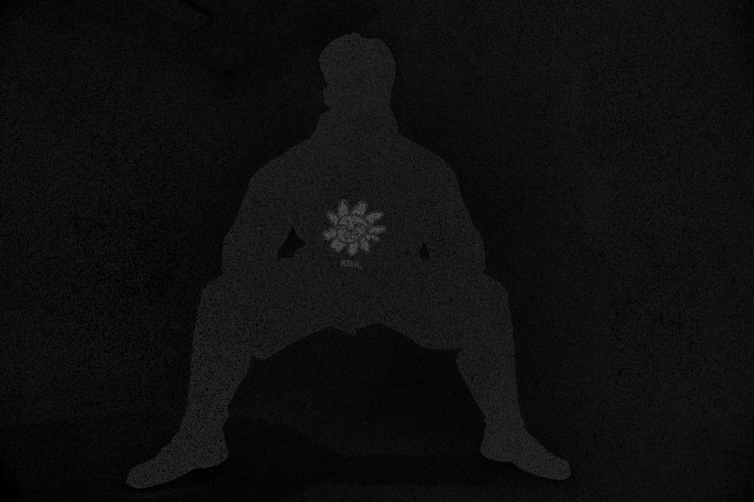 Silhouette of a person sitting cross-legged on a mat with a heart-shaped design featuring flowers on their back, against a dark background.