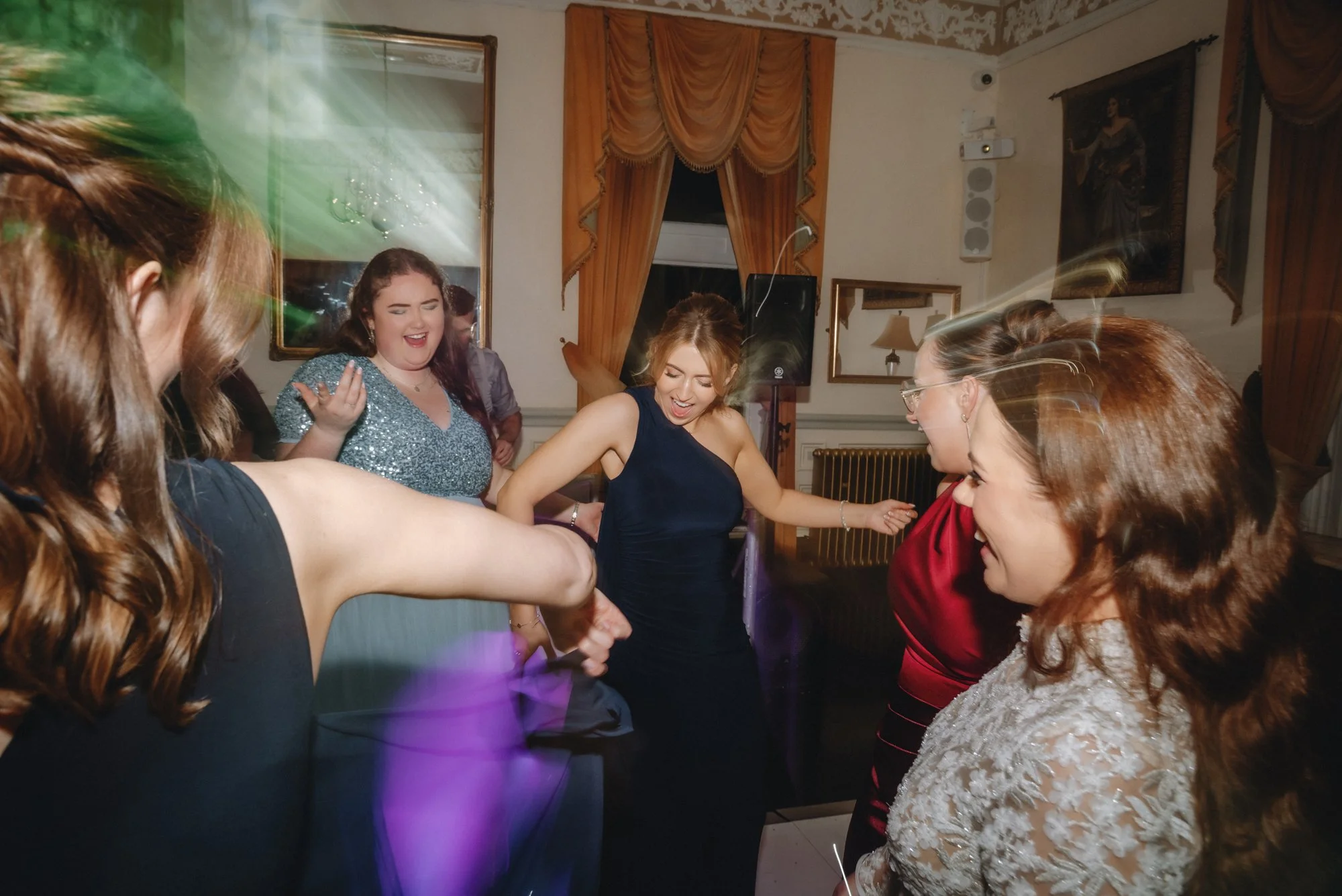 Group of women dancing and having fun at a party or celebration.