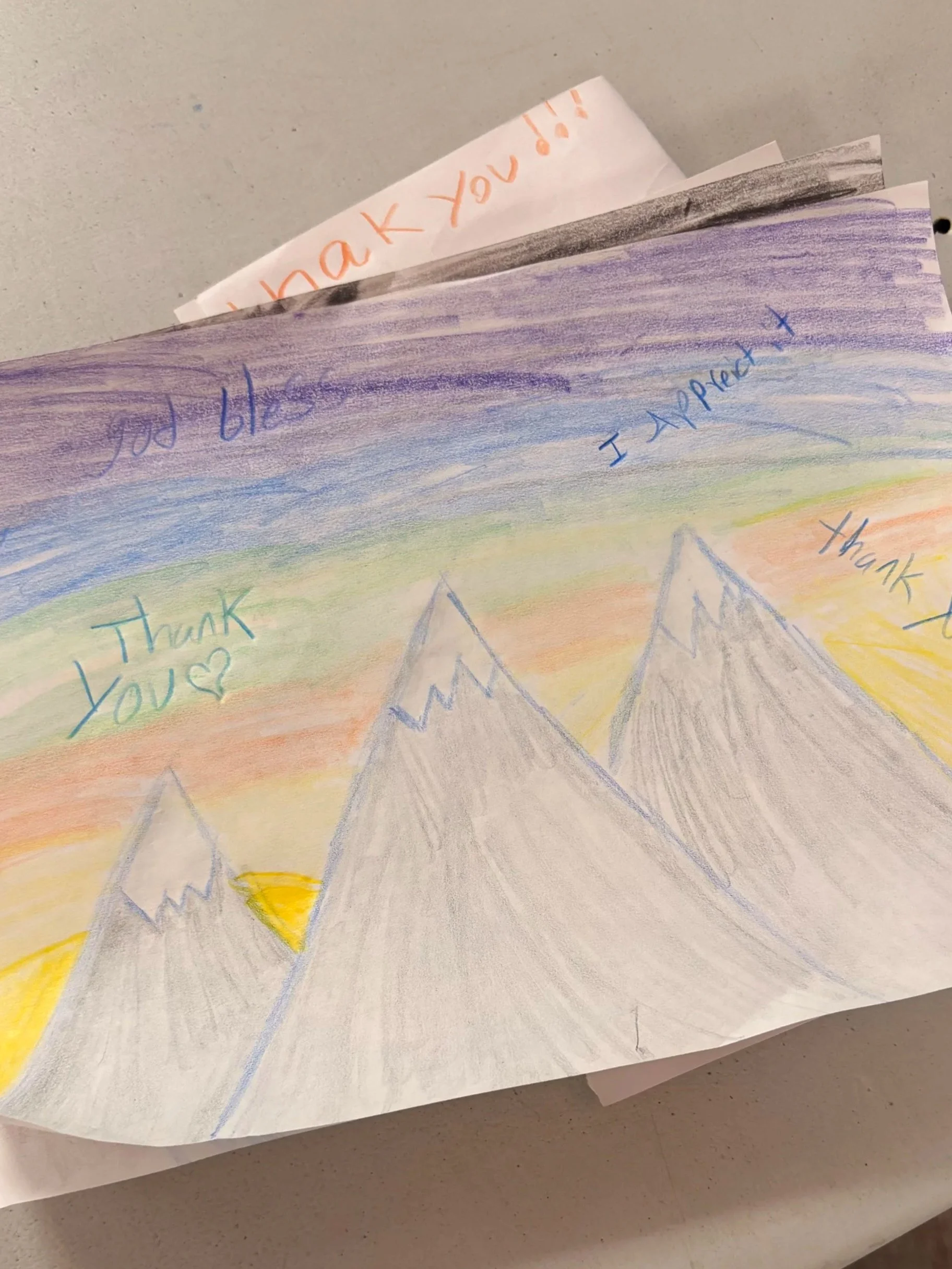 Colorful hand-drawn picture of mountains with blue, purple, yellow, and orange colors, and the words "Thank you" and "I appreciated" written on it.
