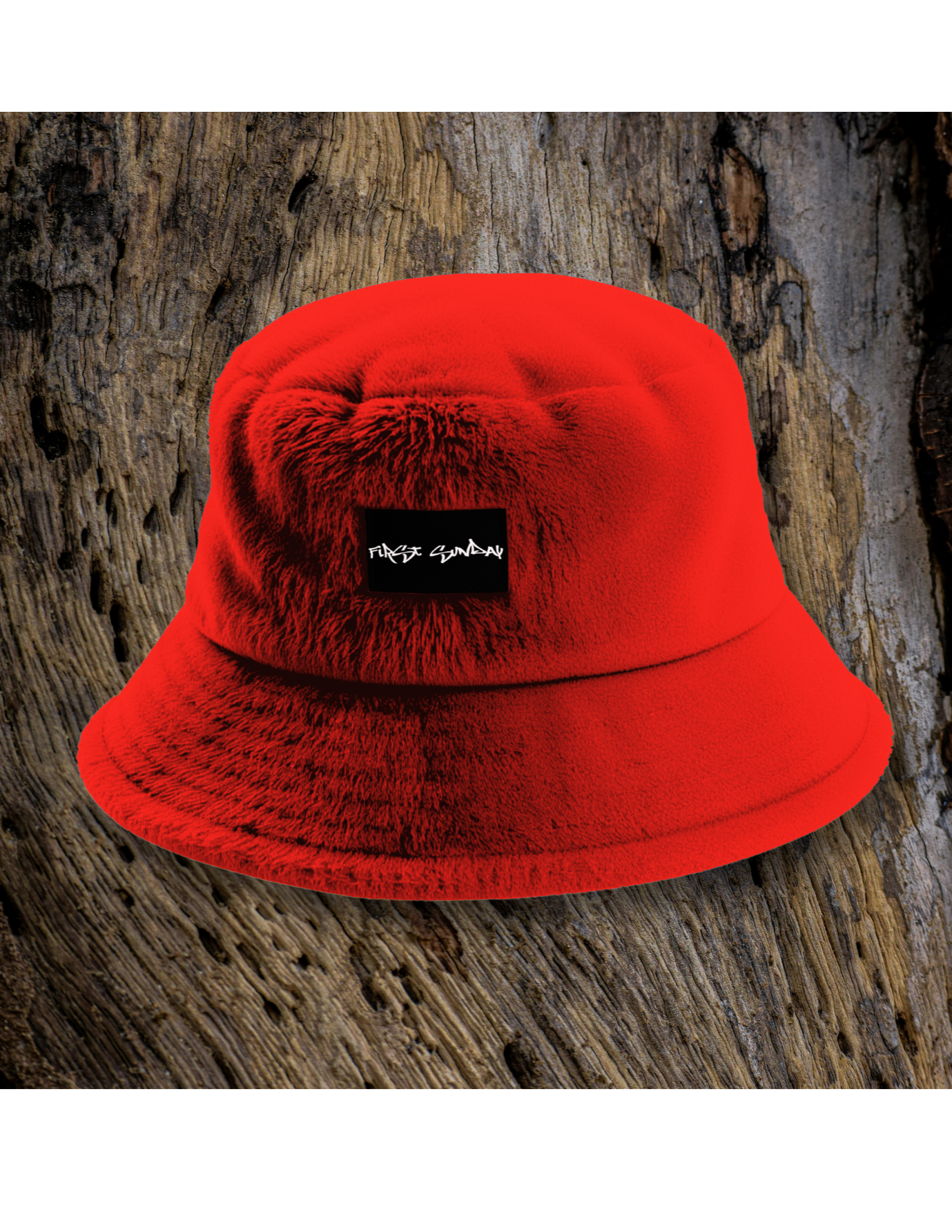 First Sunday branded red bucket hat photographed against a textured wood background.

