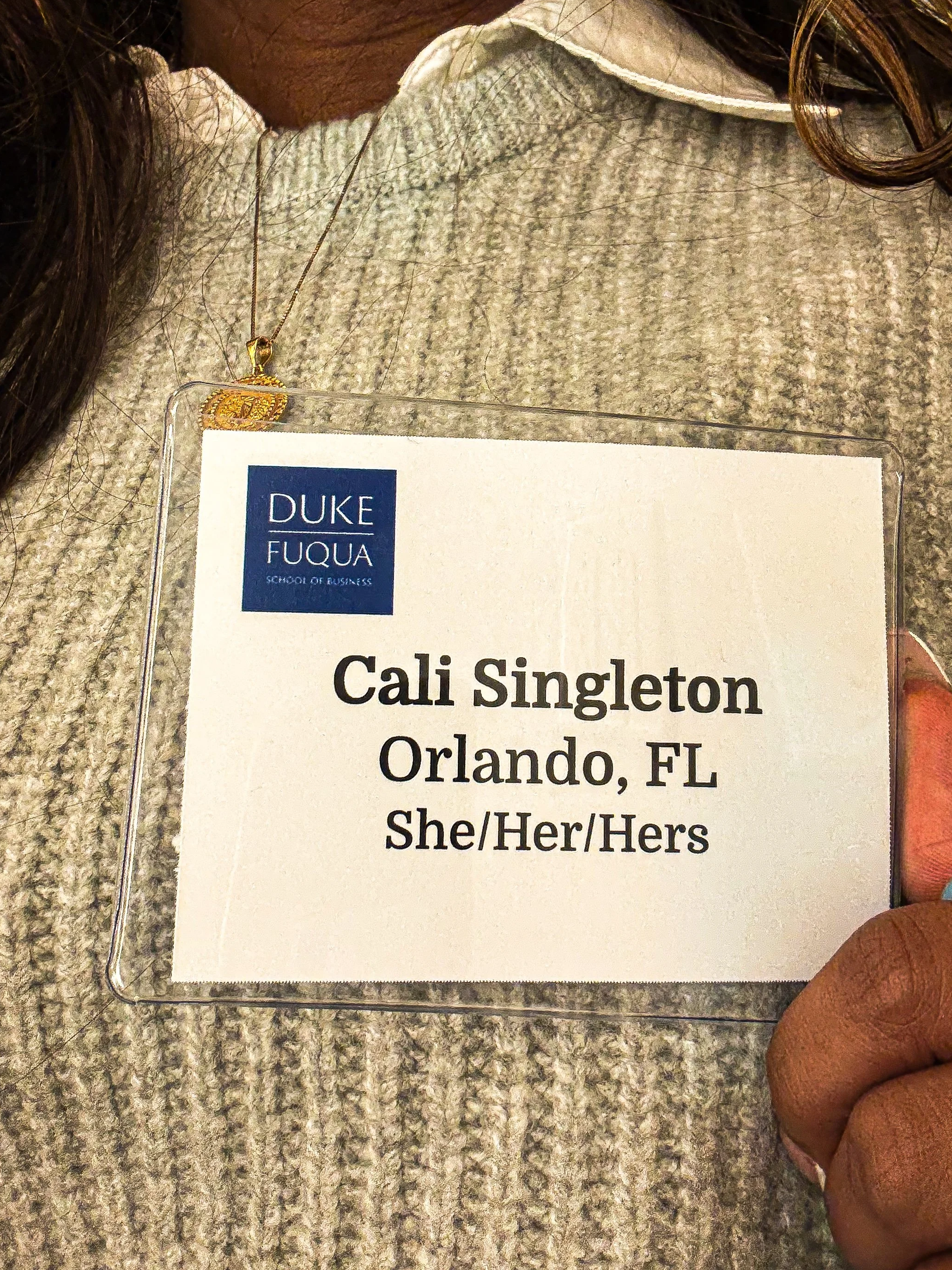 Professional name badge displaying “Cali Singleton – Orlando, FL” with pronouns and Duke Fuqua School of Business branding.