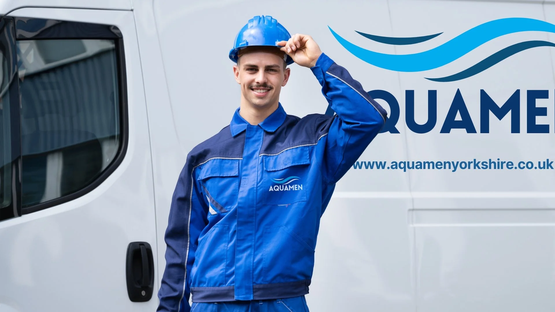 A smiling man in a blue uniform and hard hat standing in front of a white van with the logo and website of Aquamen Yorkshire.