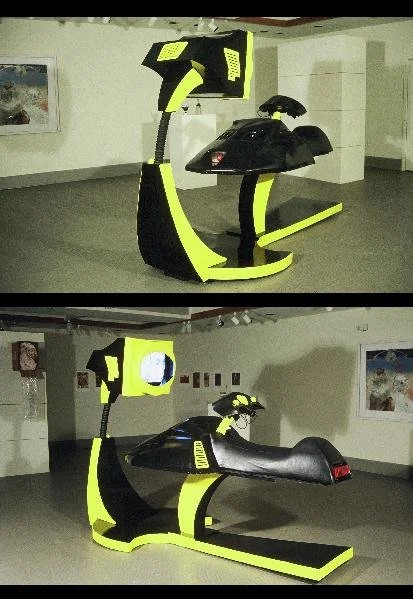 04 Toy Time Machine		HWD 7x4x8 ft
Laptop, monitor, paint, recycled steel, seat, and fiberglass parts	2025
This sculpture incorporates a video component that is operated by the handles built inside the controller to play a movie I filmed that depicts 