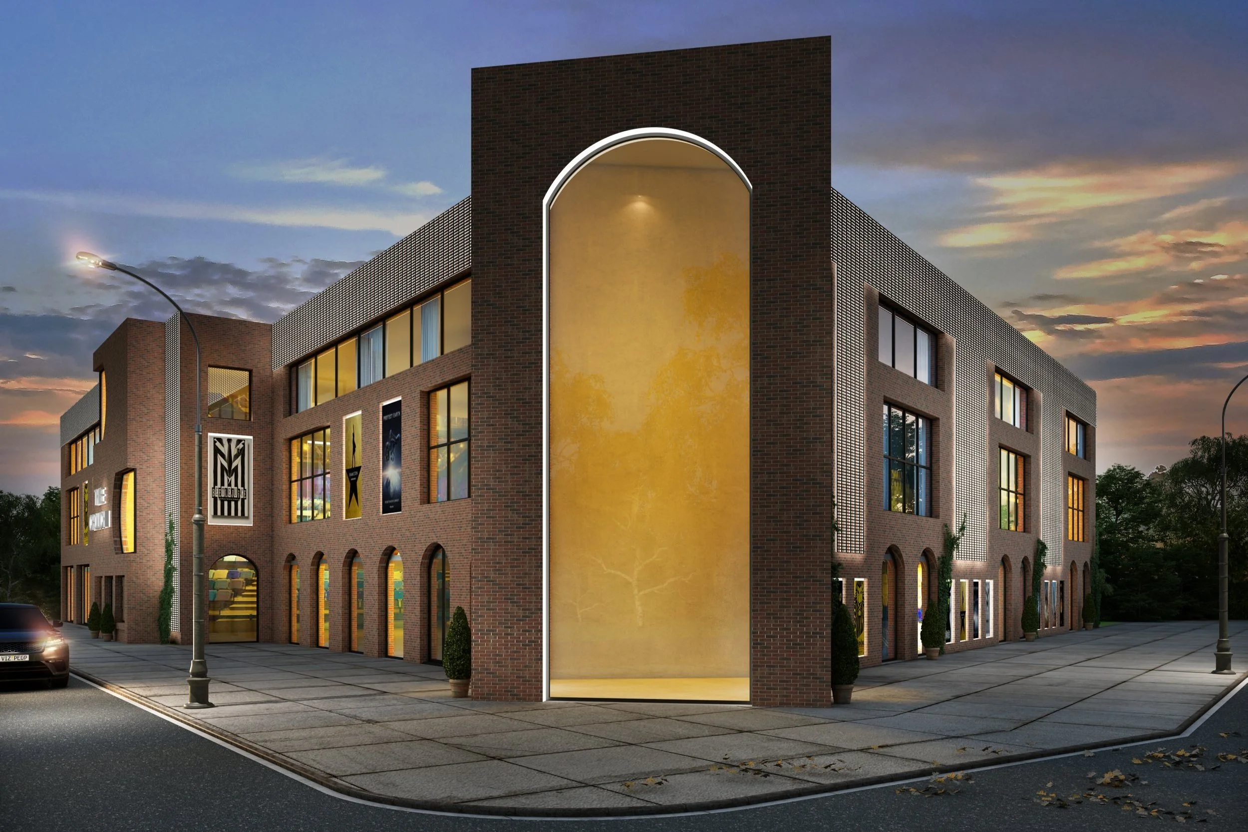 Rendering of a modern brick commercial building at dusk with large windows, decorative banners, and an illuminated archway entrance, surrounded by a sidewalk, street lamps, and a car.