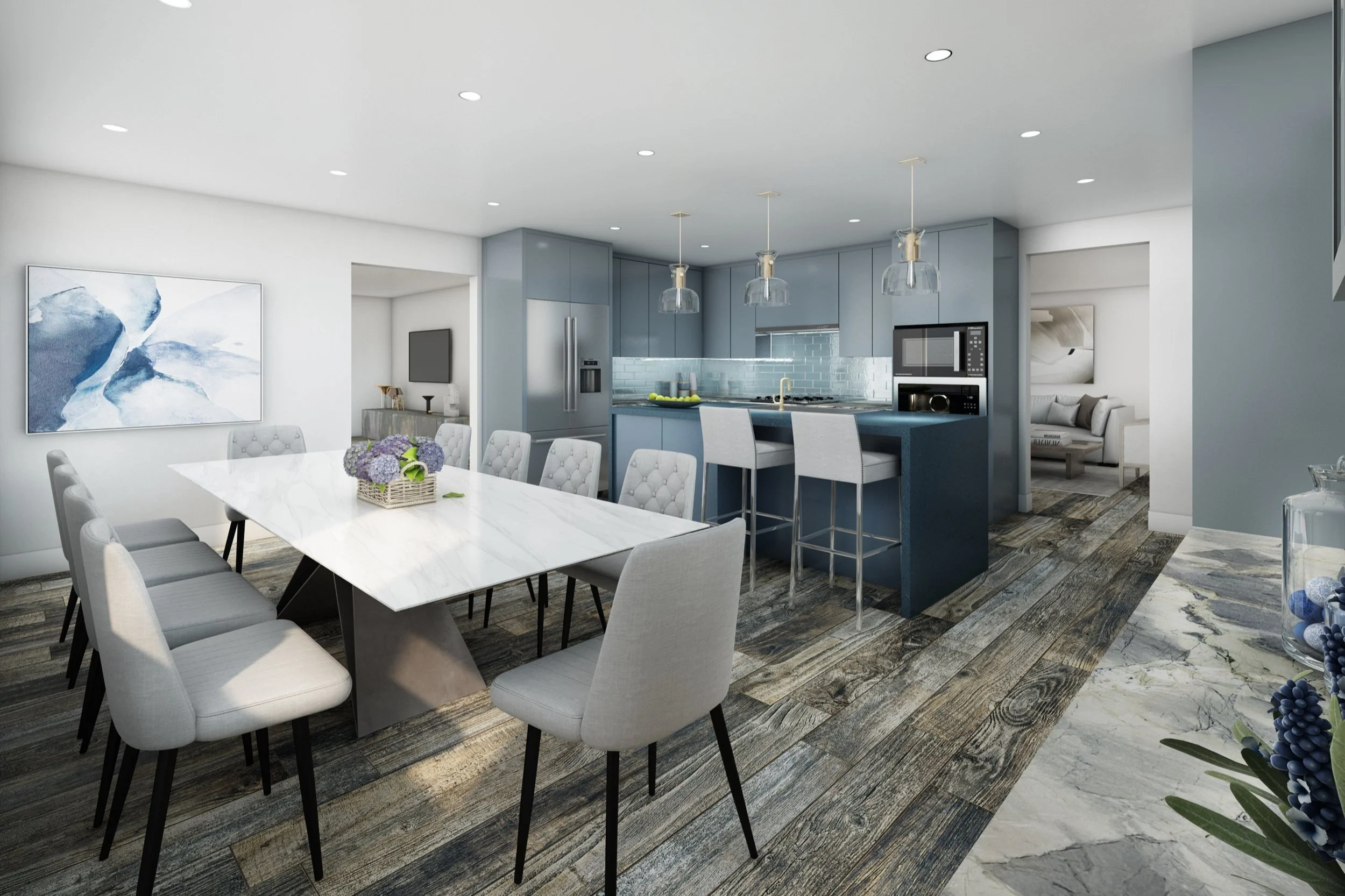 Open-concept kitchen and dining area with modern design, blue cabinets, white marble dining table, light gray upholstered chairs, pendant lighting, and hardwood and marble flooring.