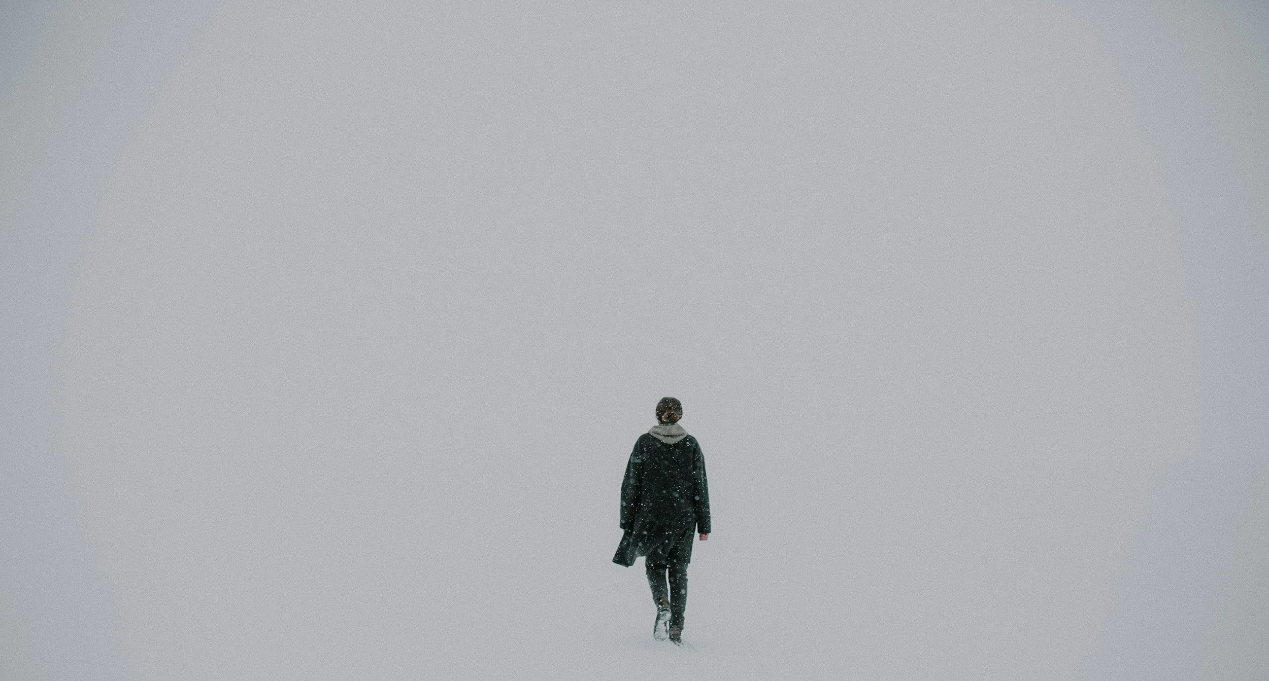A woman walking in the snow representing sensory awareness in a fast paced world.
